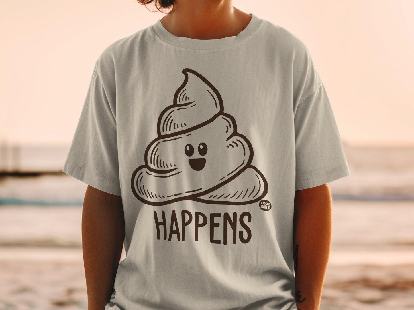 T-shirt with a cartoon poop emoji and the text "HAPPENS".