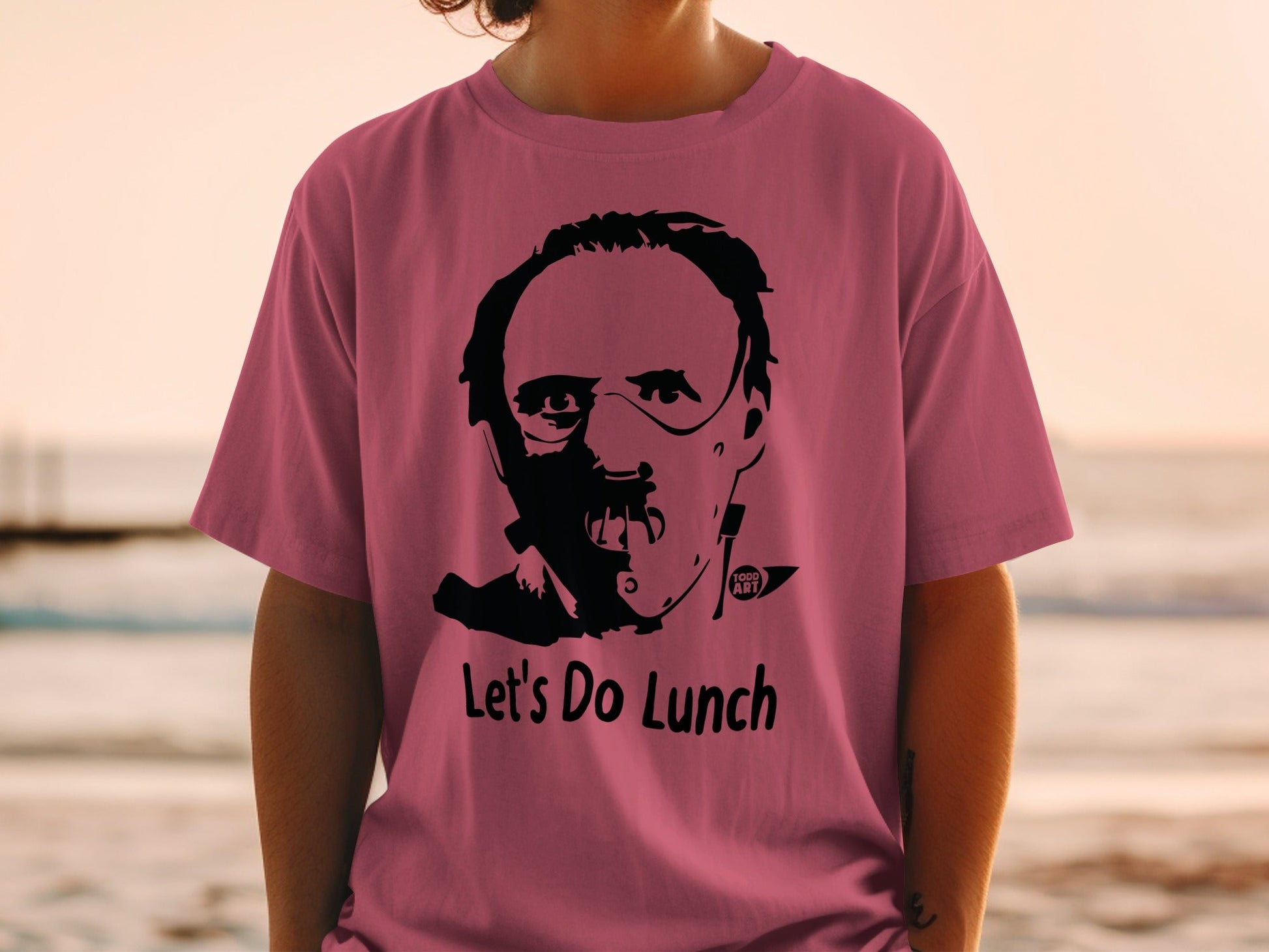 Pink t-shirt with Hannibal Lecter mask and "Let's Do Lunch" text.