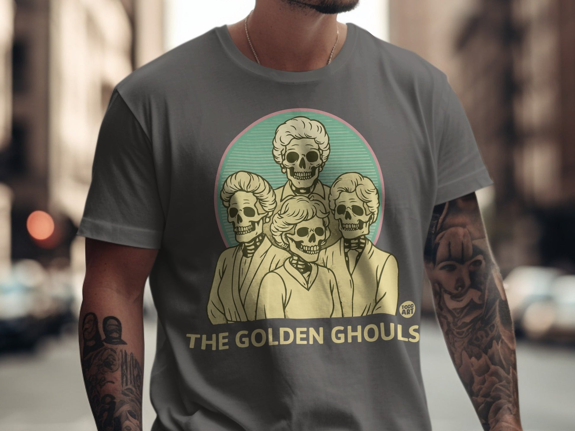 The Golden Ghouls graphic on a grey t-shirt.