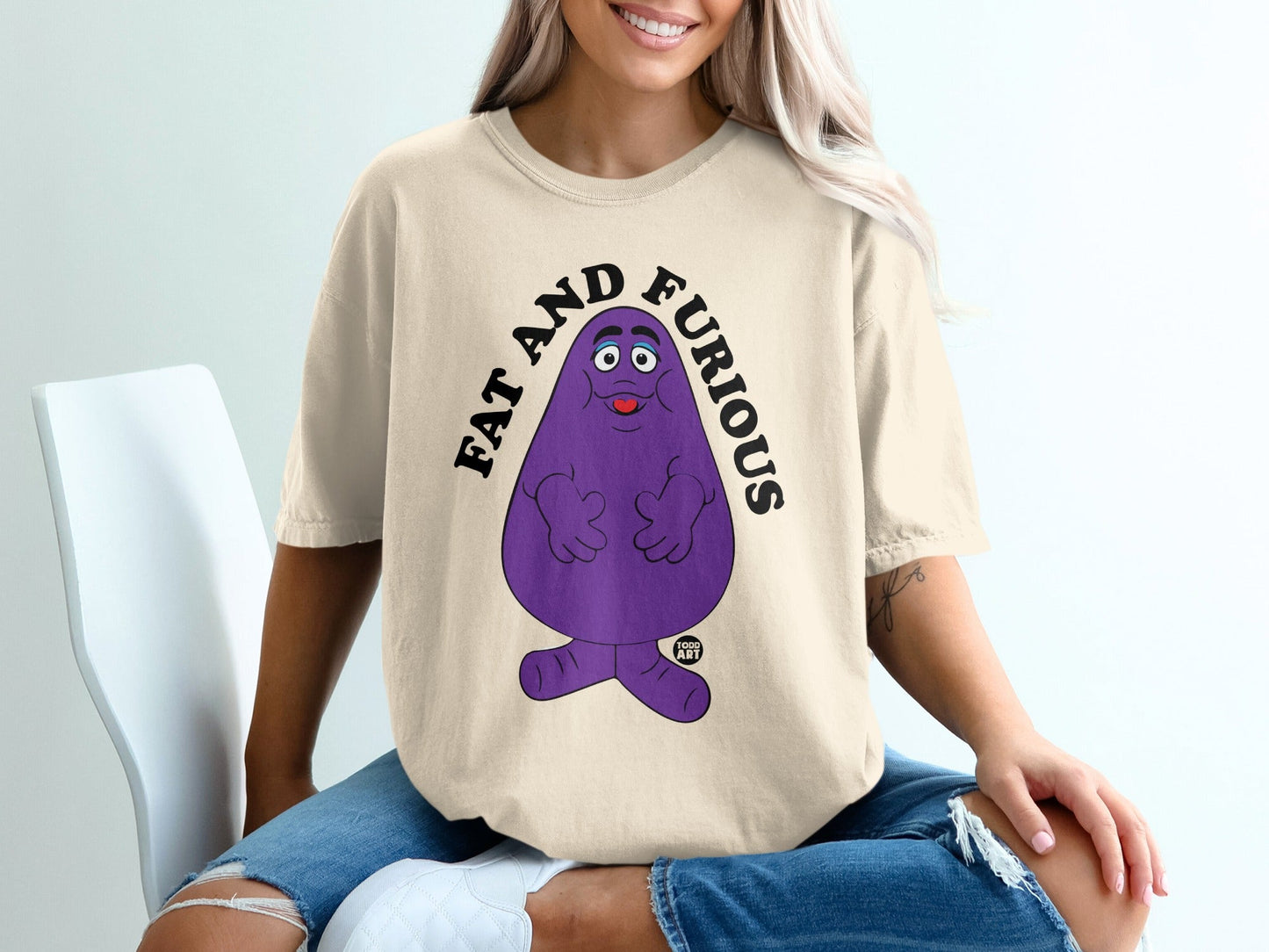 Cream t-shirt with purple Grimace character and "FAT AND FURIOUS" text.