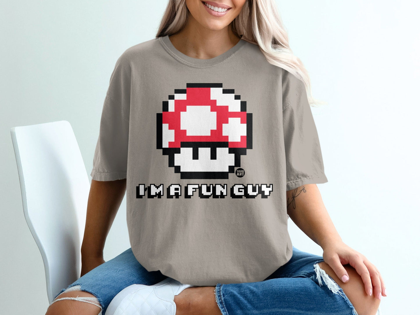 Tan t-shirt with pixelated red and white mushroom and "I'M A FUN GUY" text.