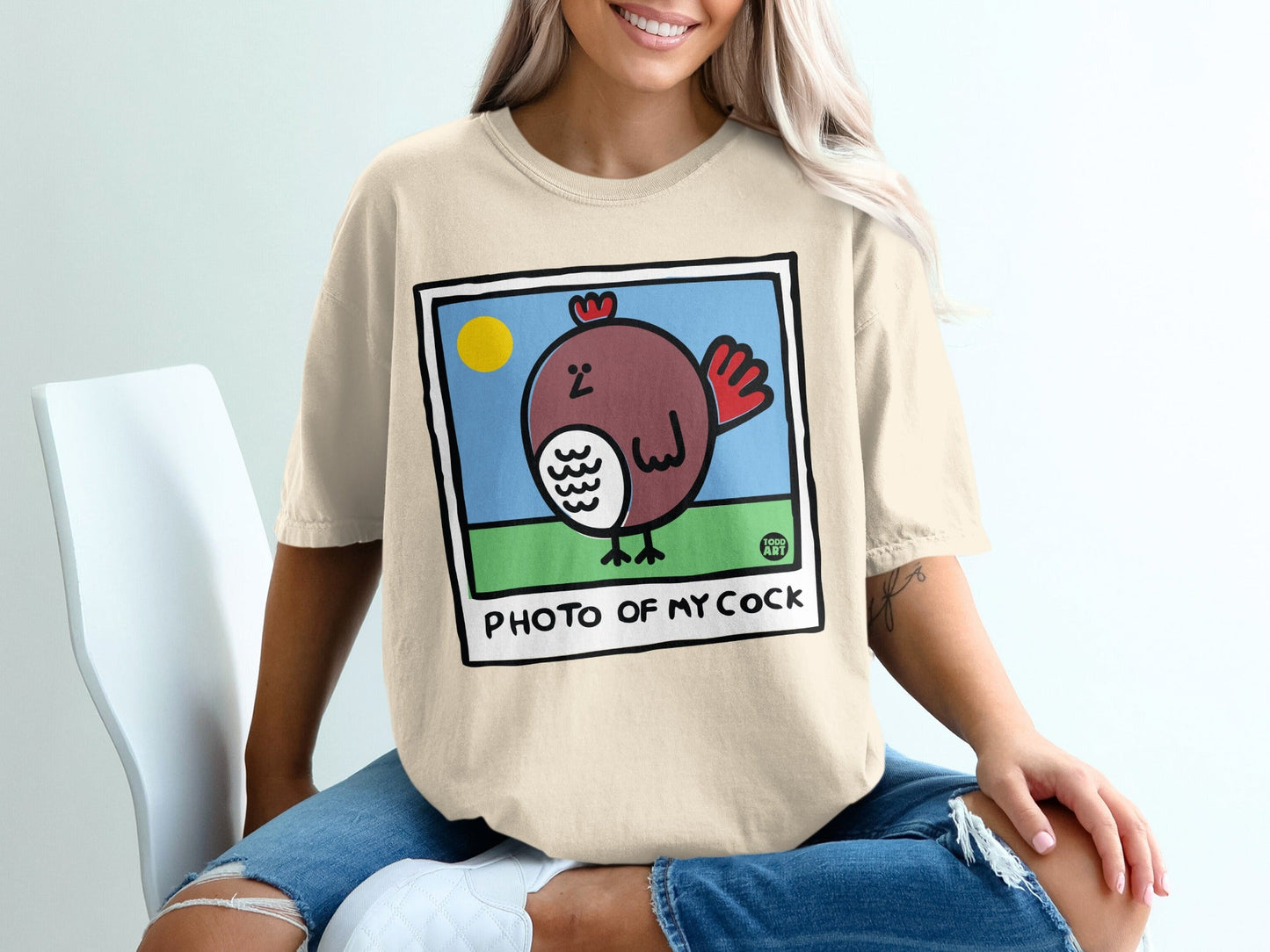 T-shirt graphic: cartoon chicken in square frame with text "PHOTO OF MY COCK".