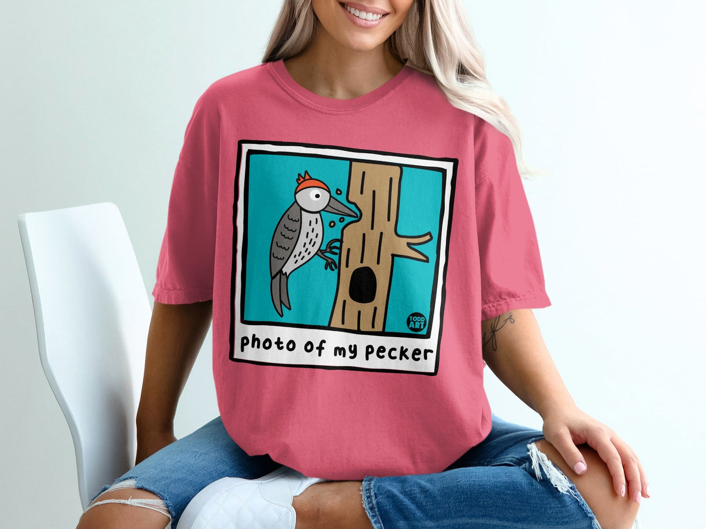 Illustration of a woodpecker on a tree trunk with "Photo of my pecker" text.