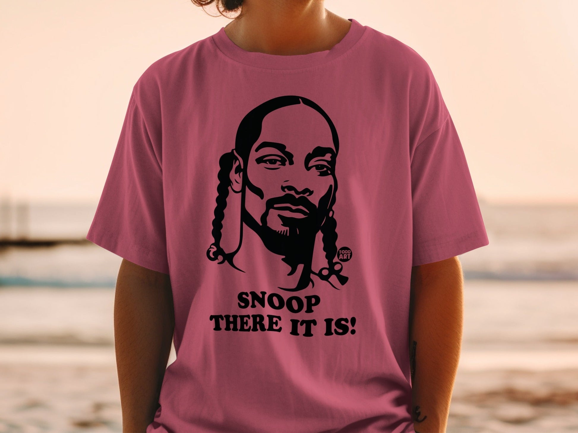 T-shirt featuring Snoop Dogg portrait and "Snoop There It Is!" text.