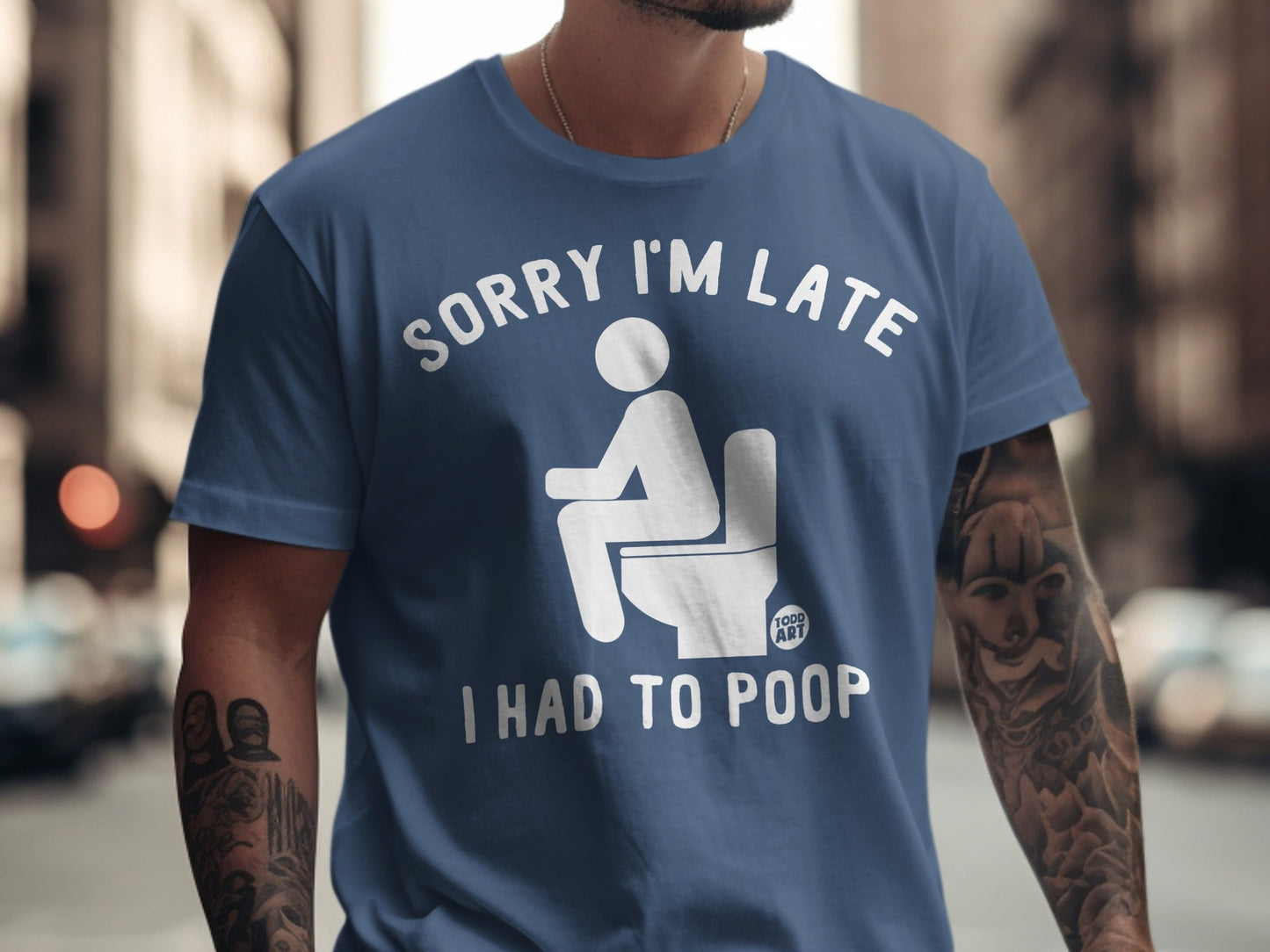 Blue t-shirt with "Sorry I'm Late I Had To Poop" text and toilet graphic.