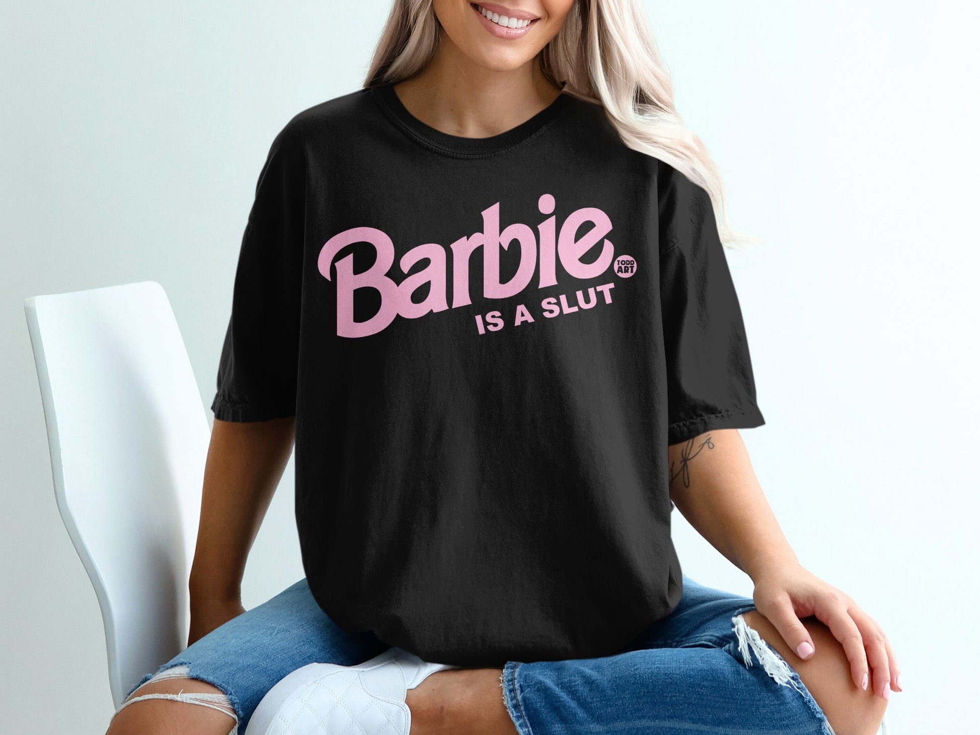 Black t-shirt with pink "Barbie is a SLUT" text.