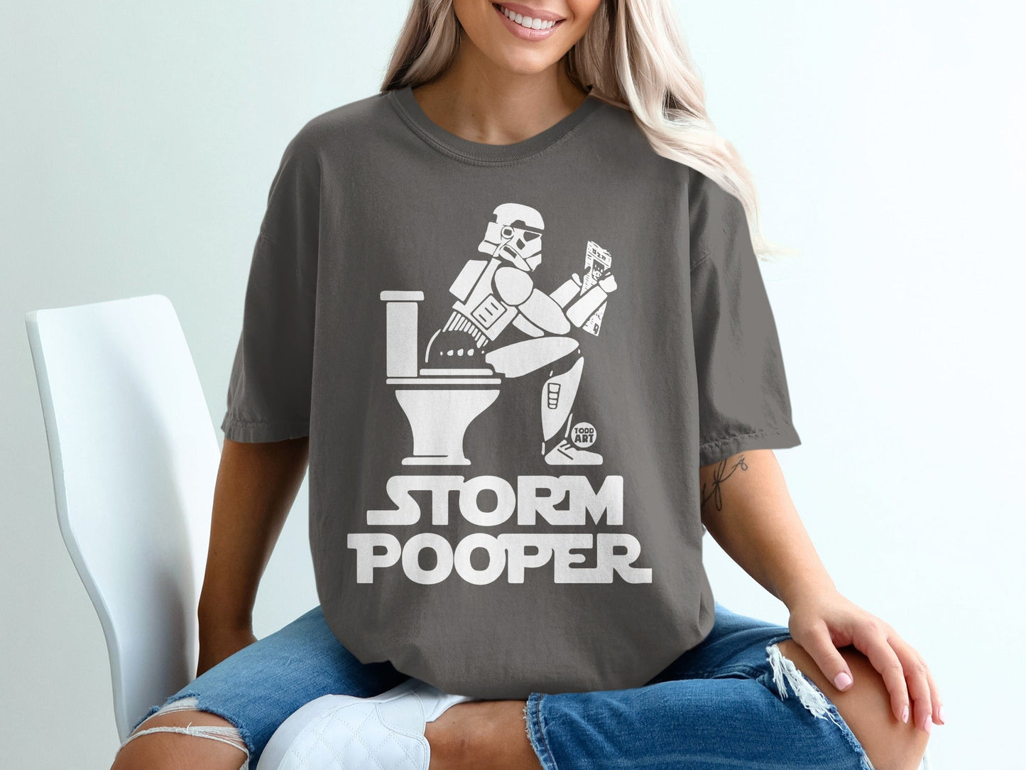 Stormtrooper on toilet with phone, "Storm Pooper" text.