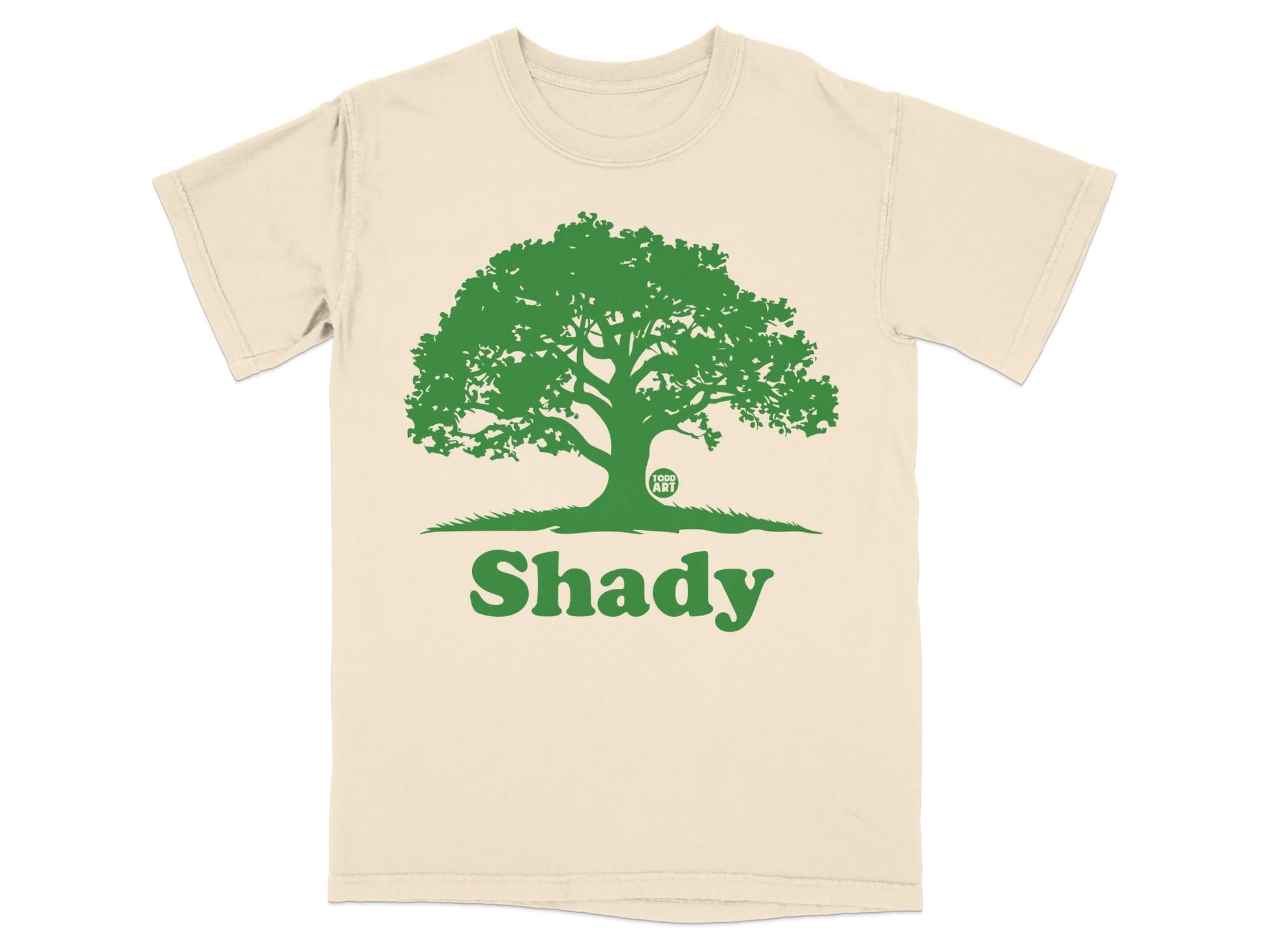 Beige t-shirt with green "Shady" text and a large oak tree graphic.