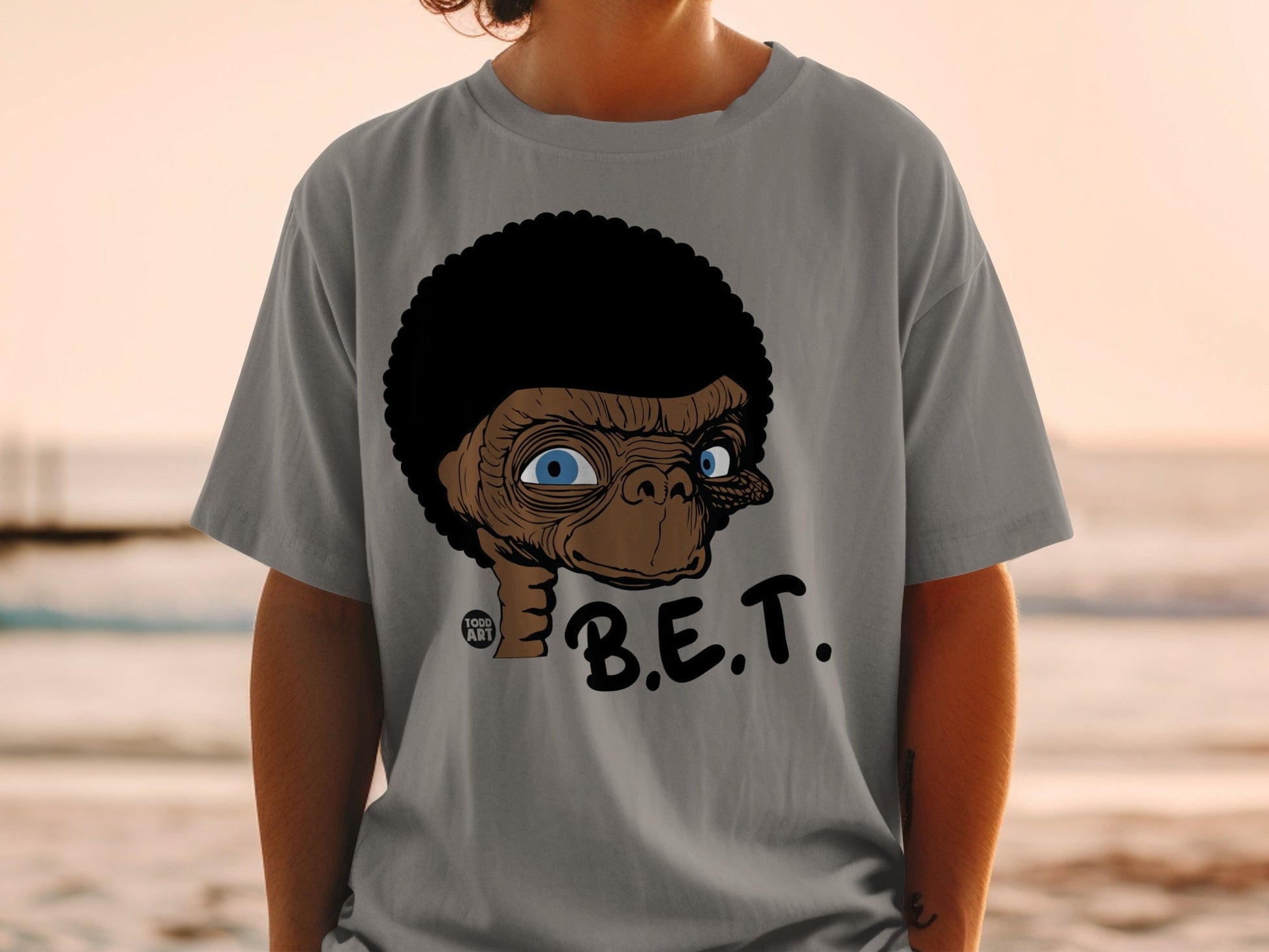 T-shirt featuring a stylized ET character with an afro, blue eyes, and "B.E.T." text.