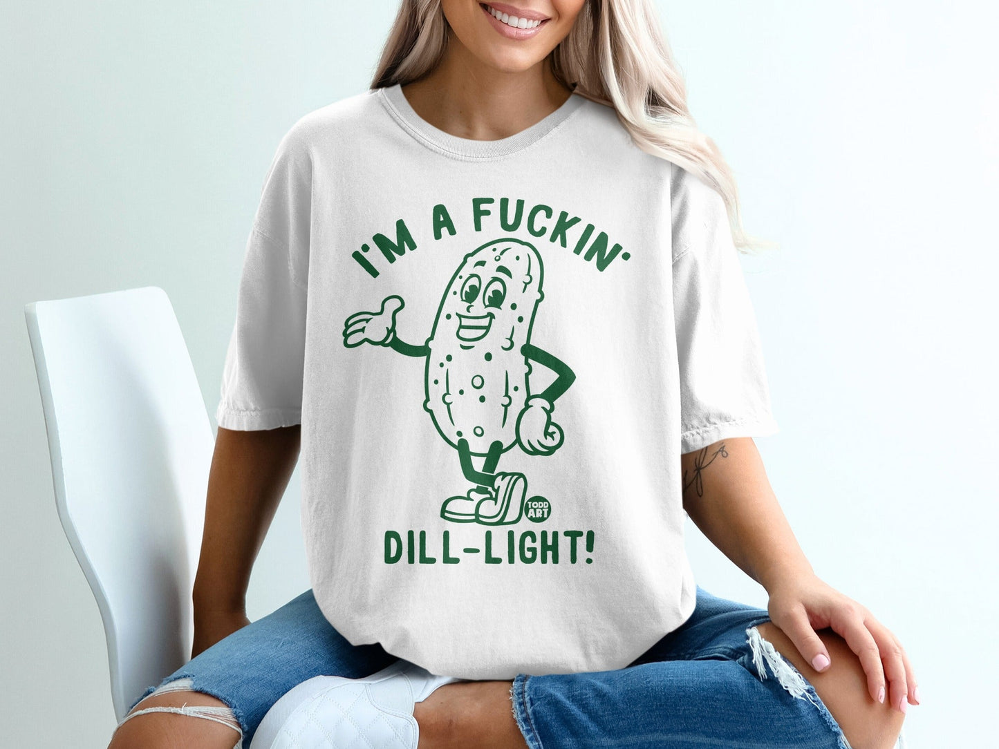 White t-shirt with cartoon pickle saying "I'm a fuckin' dill-light!"