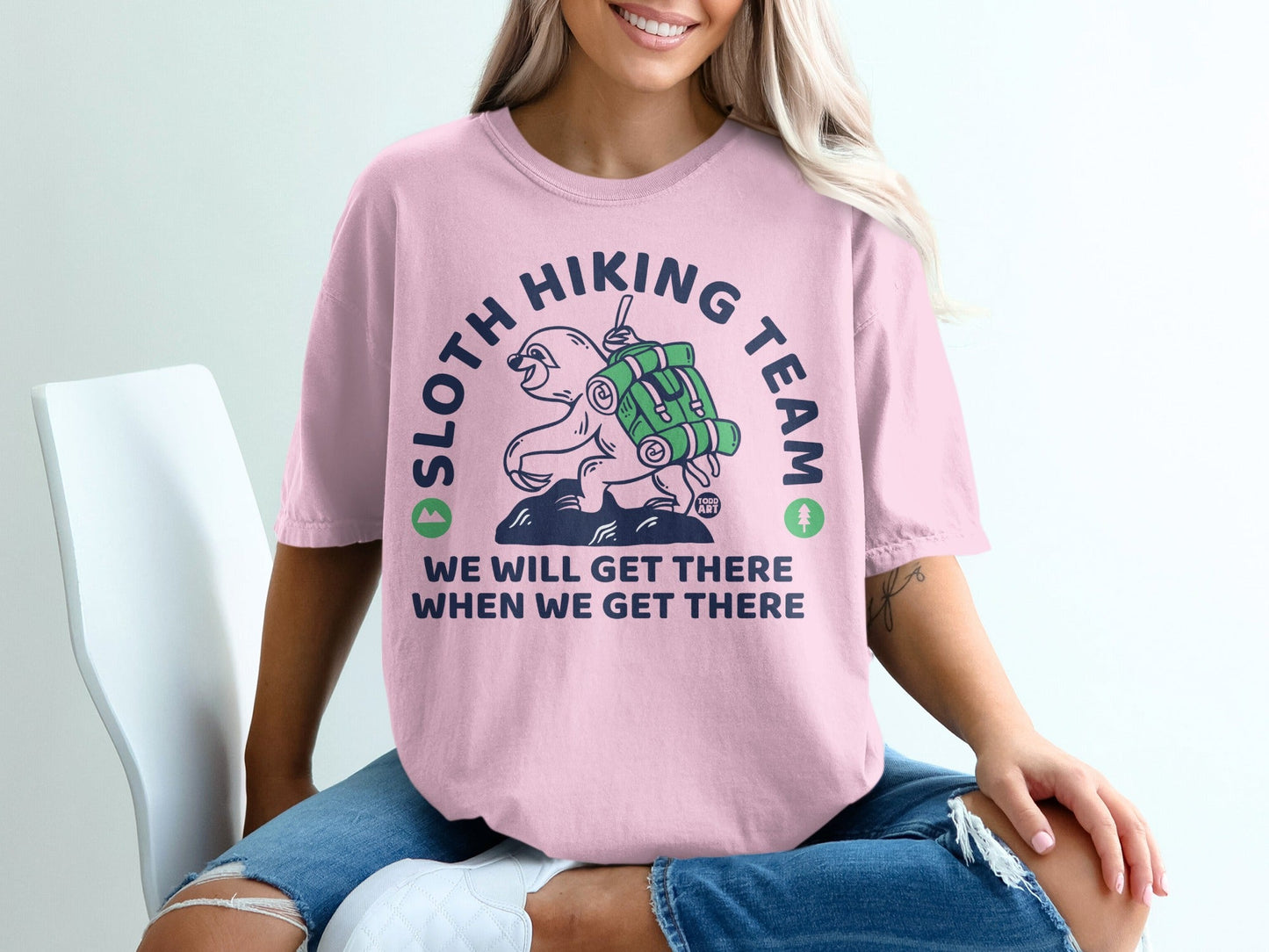 Pink t-shirt with sloth hiking graphic and text "Sloth Hiking Team We will get there when we get there".