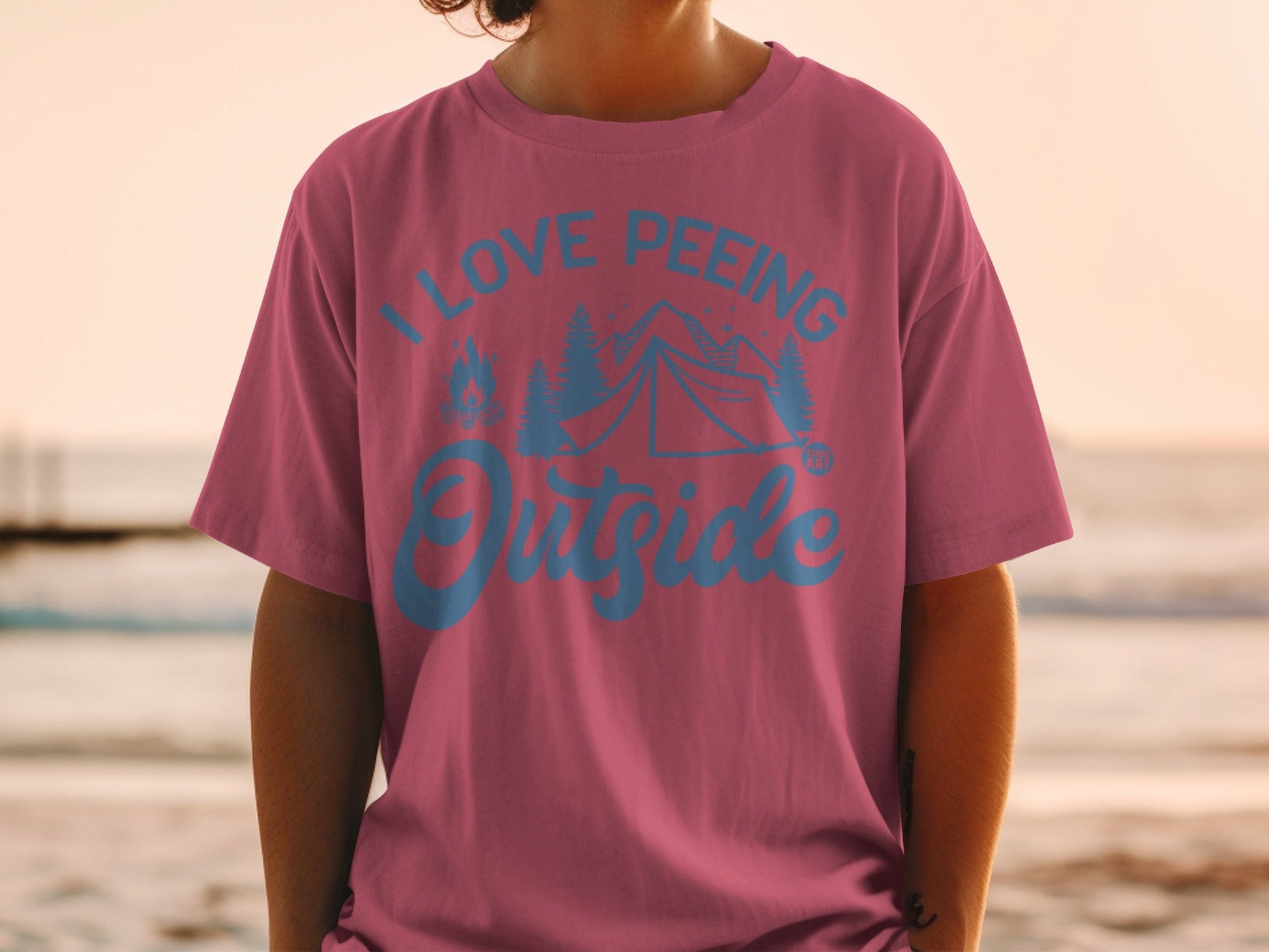 Pink t-shirt with text "I LOVE PEEING Outside" and camping graphics.