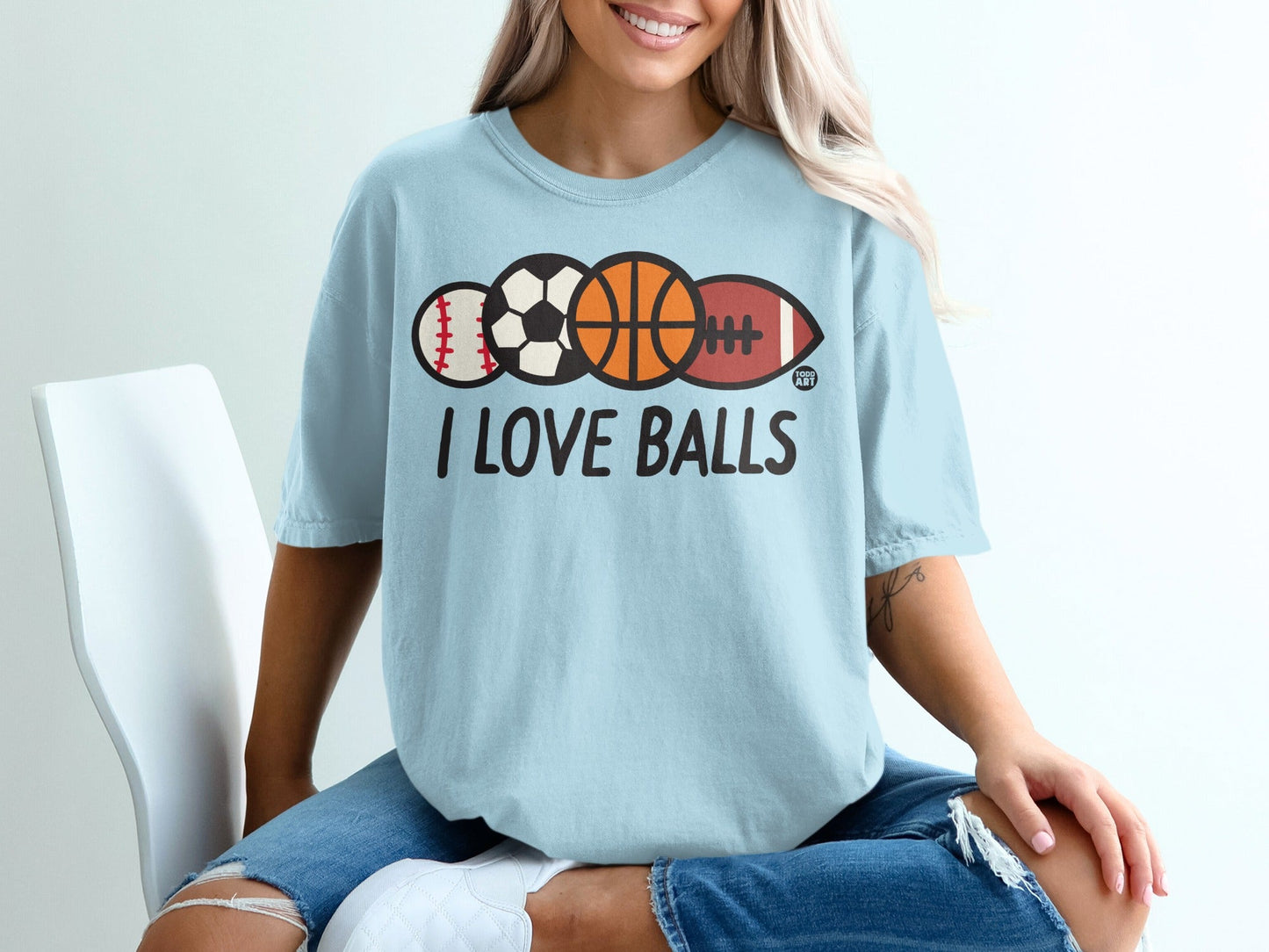 Light blue t-shirt with "I LOVE BALLS" and sports balls.