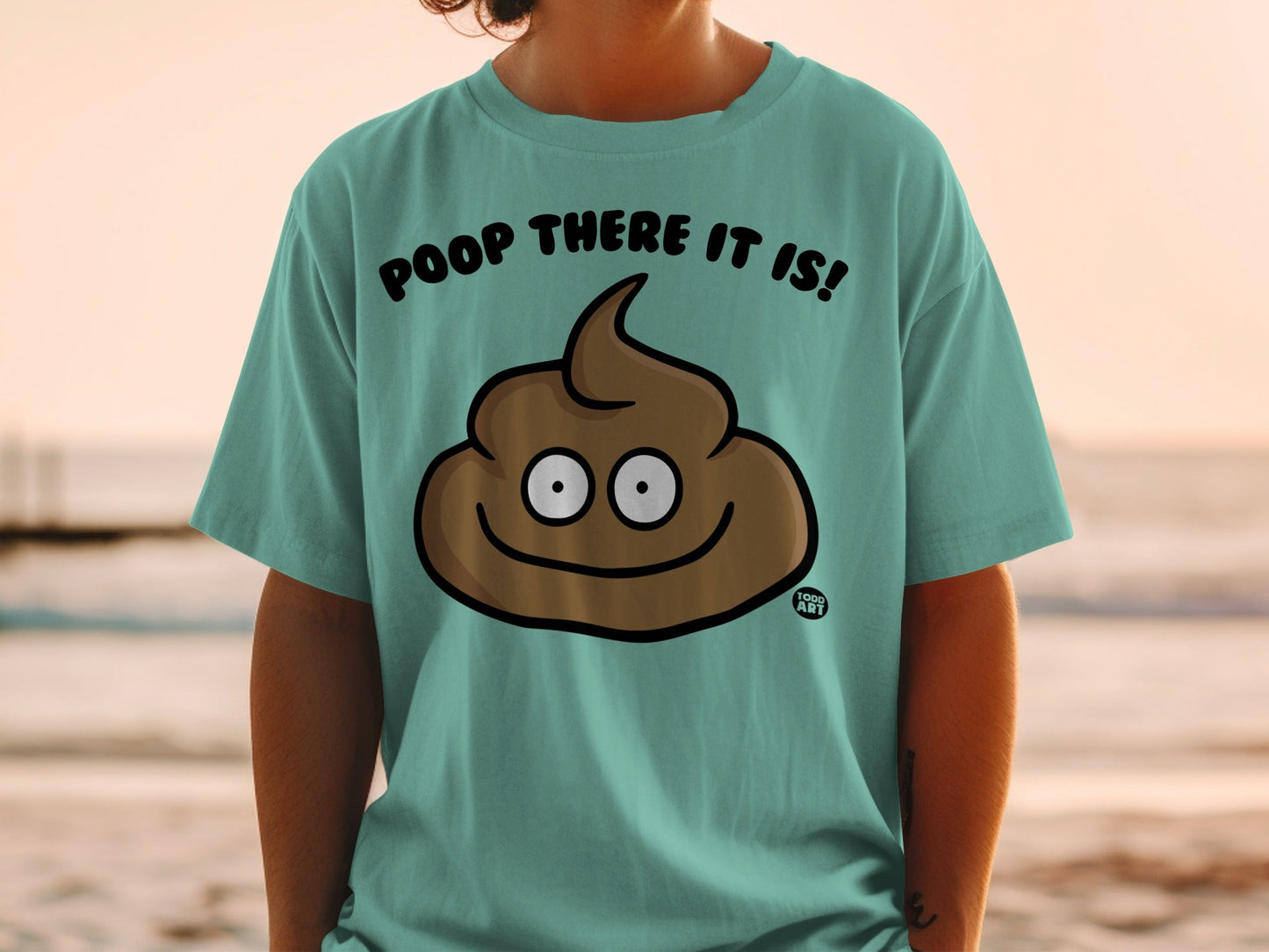 Teal t-shirt with a cartoon poop emoji that says "Poop there it is!".