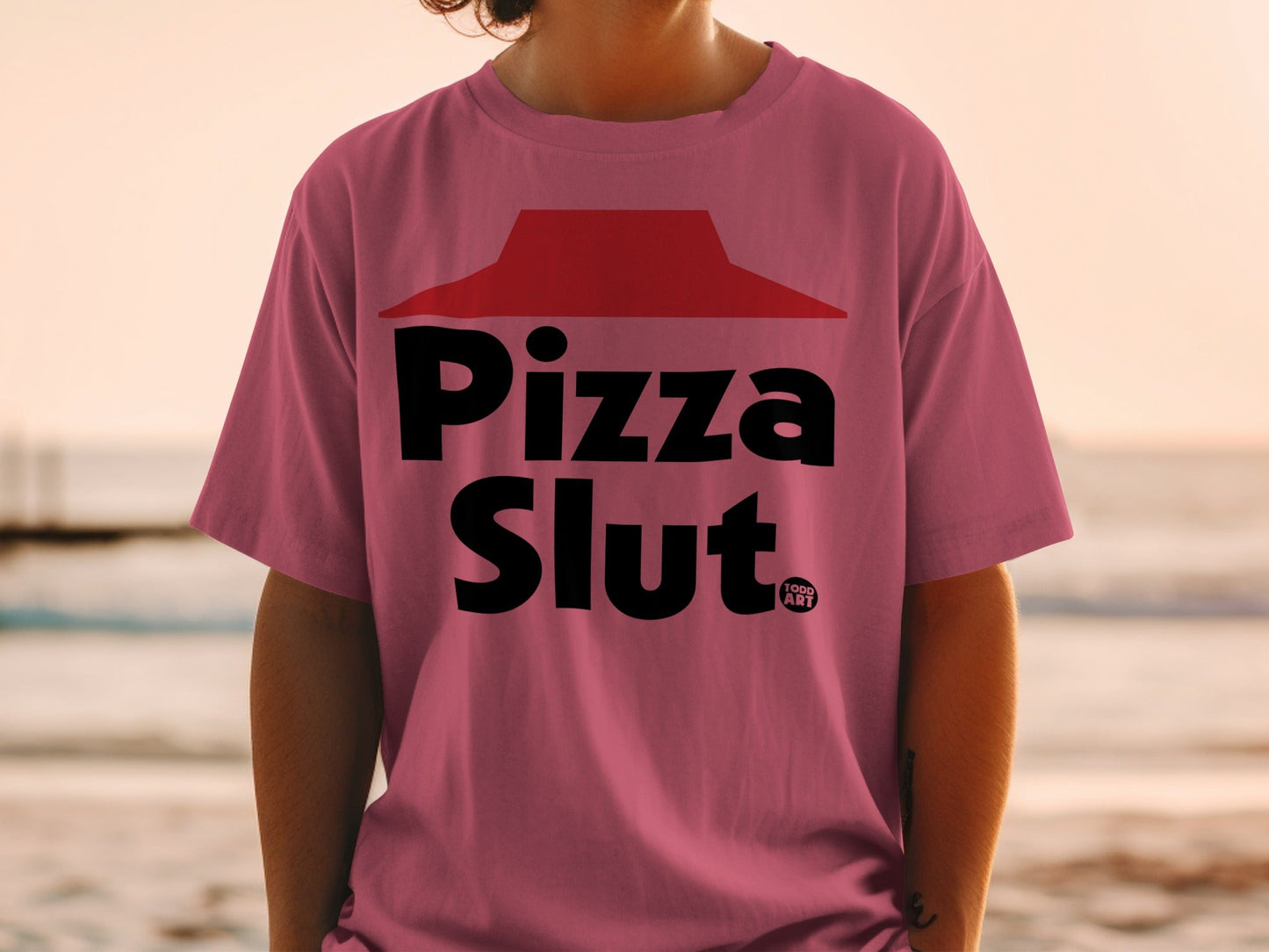 Pink t-shirt with "Pizza Slut" text and a red hat logo.