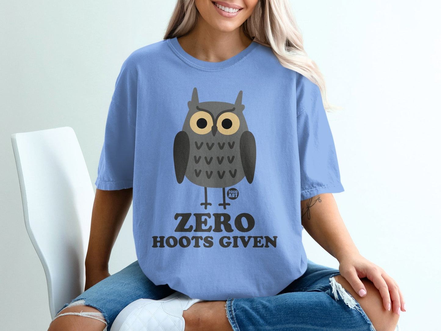 Blue t-shirt with cartoon owl graphic and text "Zero Hoots Given".