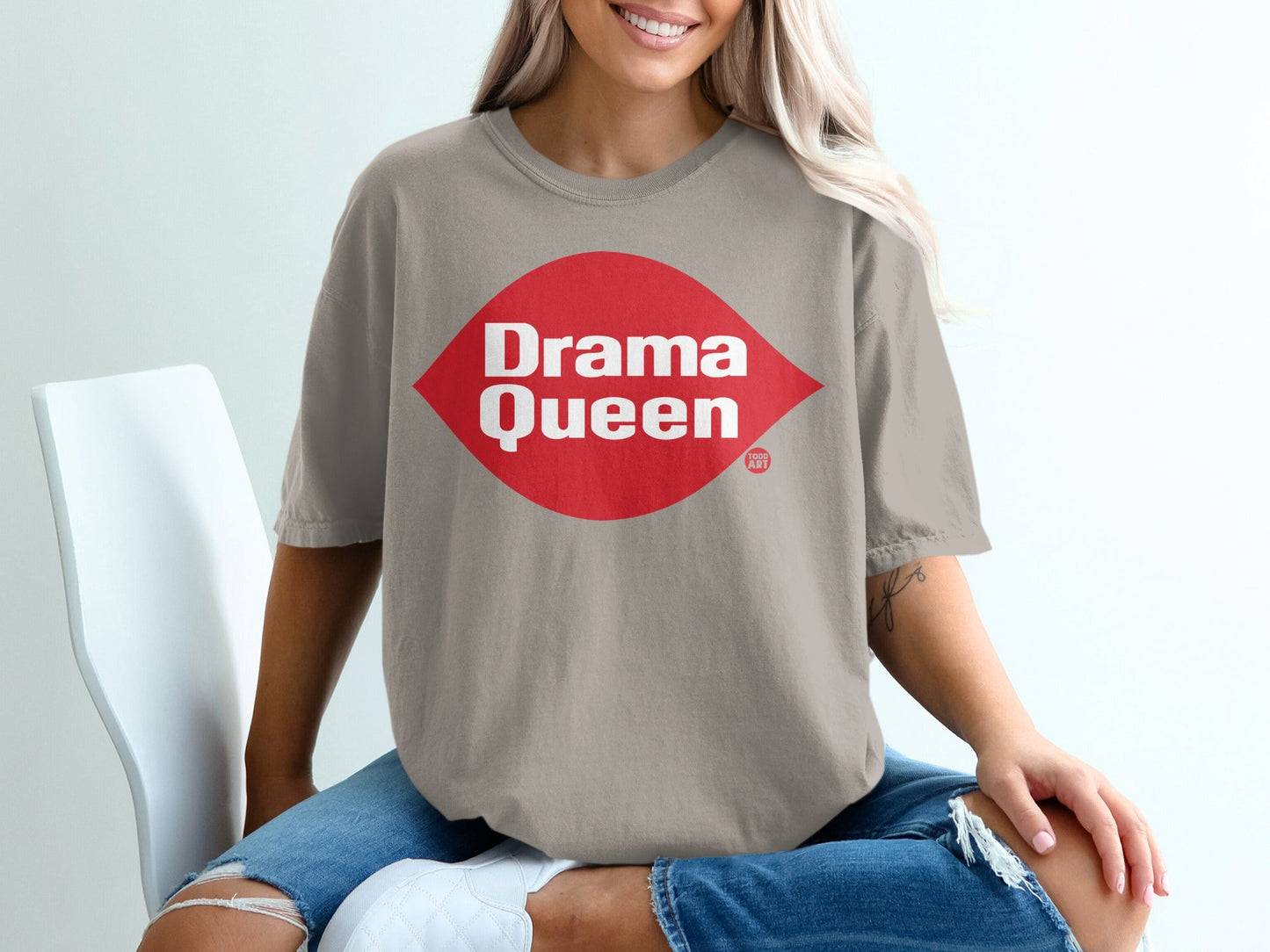 Tan t-shirt with red oval graphic that says "Drama Queen"