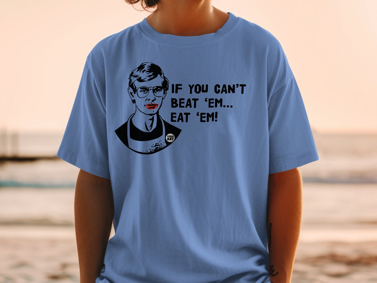 T-shirt with a black and white illustration of Ruth Bader Ginsburg and the text "IF YOU CAN'T BEAT 'EM... EAT 'EM!".