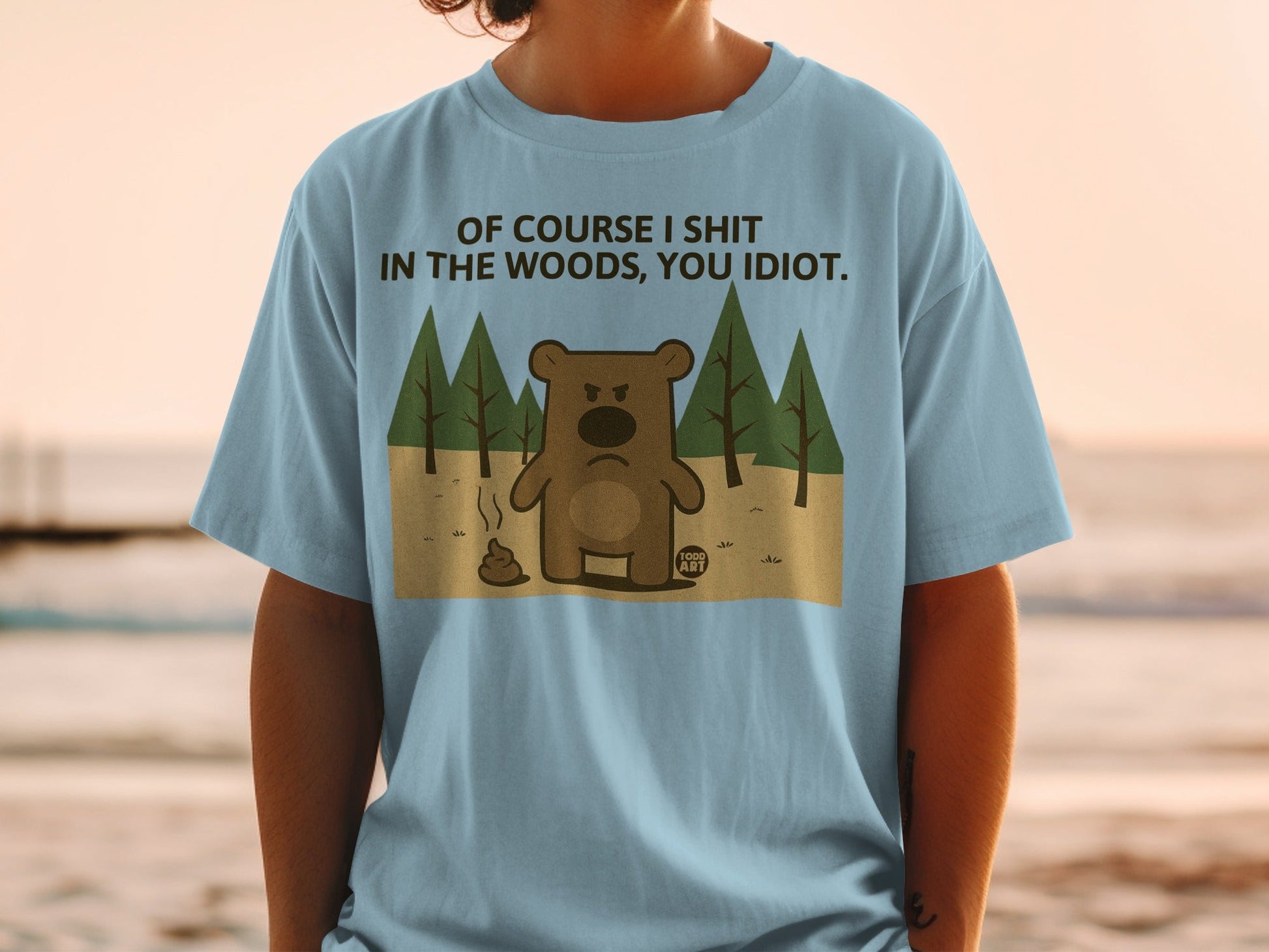 Blue t-shirt with cartoon bear and text: "Of course I shit in the woods, you idiot."