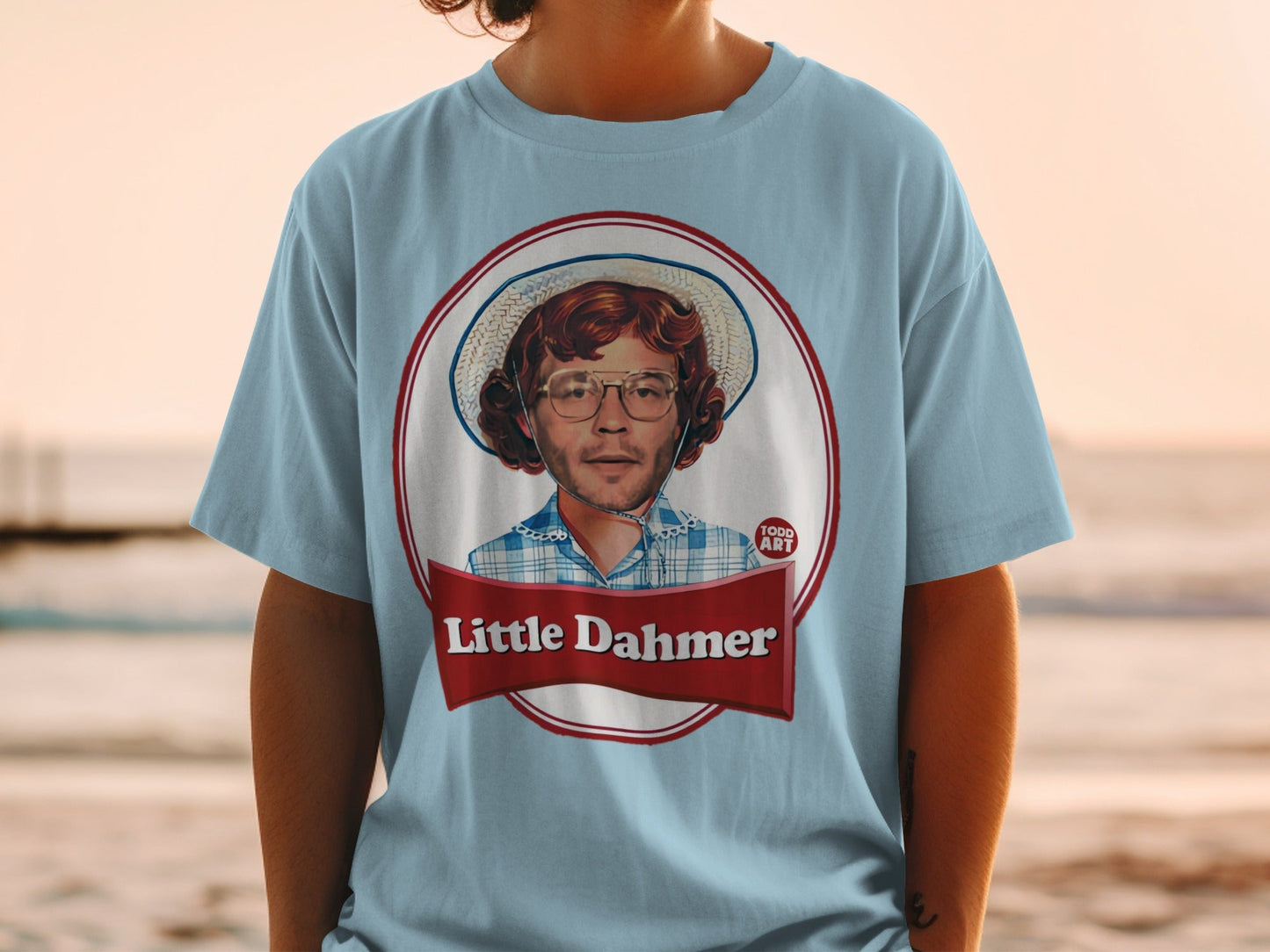 Light blue t-shirt with "Little Dahmer" graphic featuring a man in a straw hat.