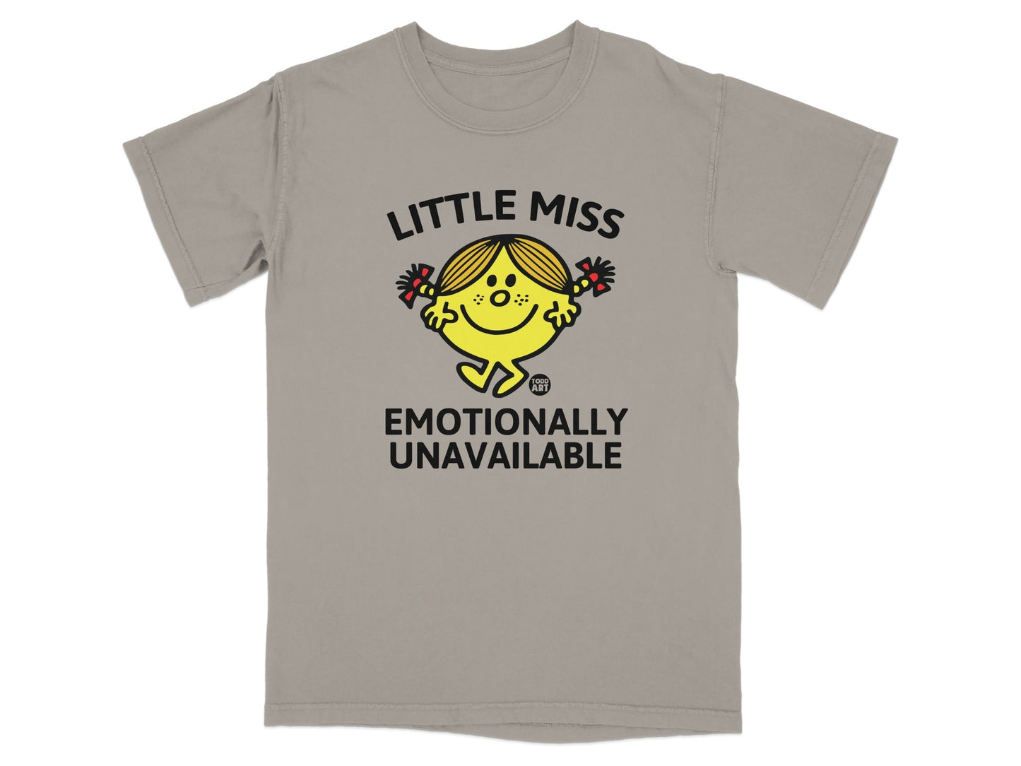 Little Miss character with pigtails and red bows, "Emotionally Unavailable" text on a tan t-shirt.