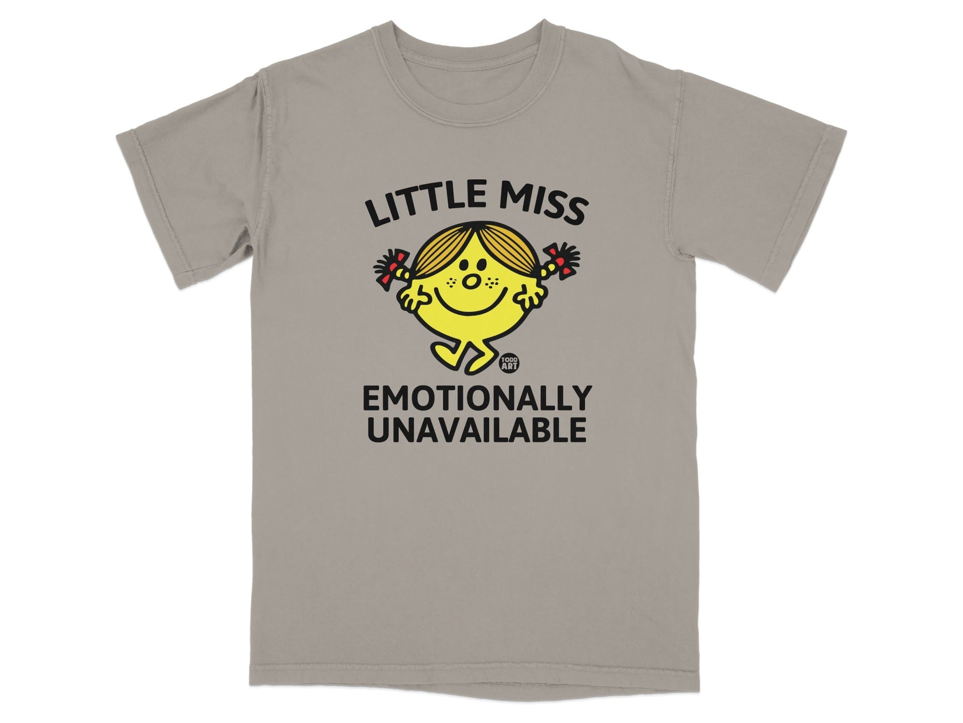 Little Miss character with pigtails and red bows, "Emotionally Unavailable" text on a tan t-shirt.