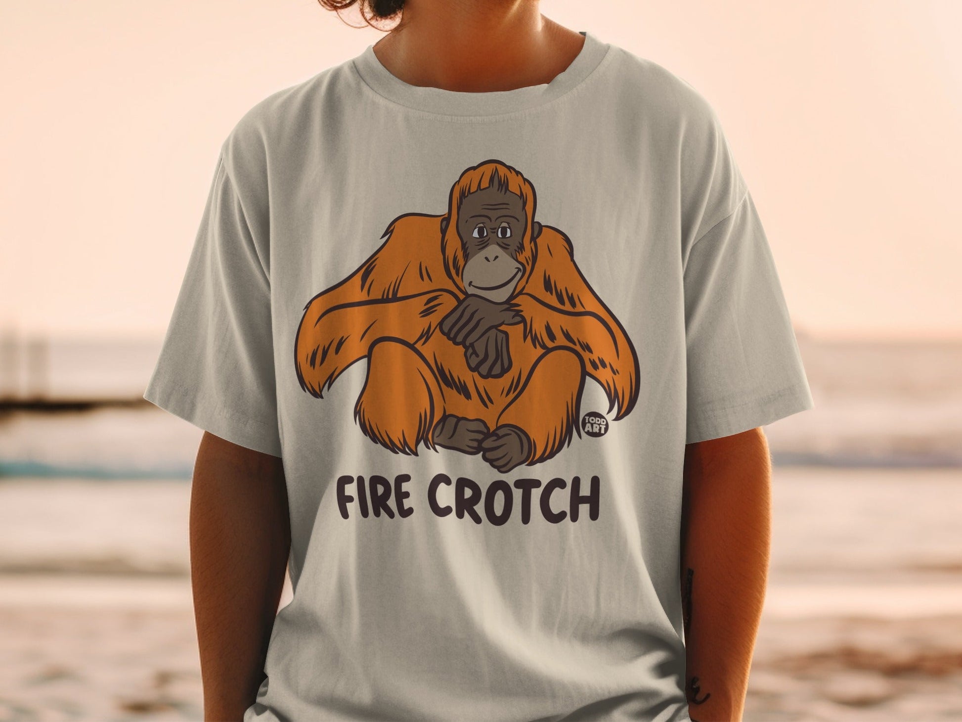 T-shirt featuring a cartoon orangutan with "FIRE CROTCH" text.