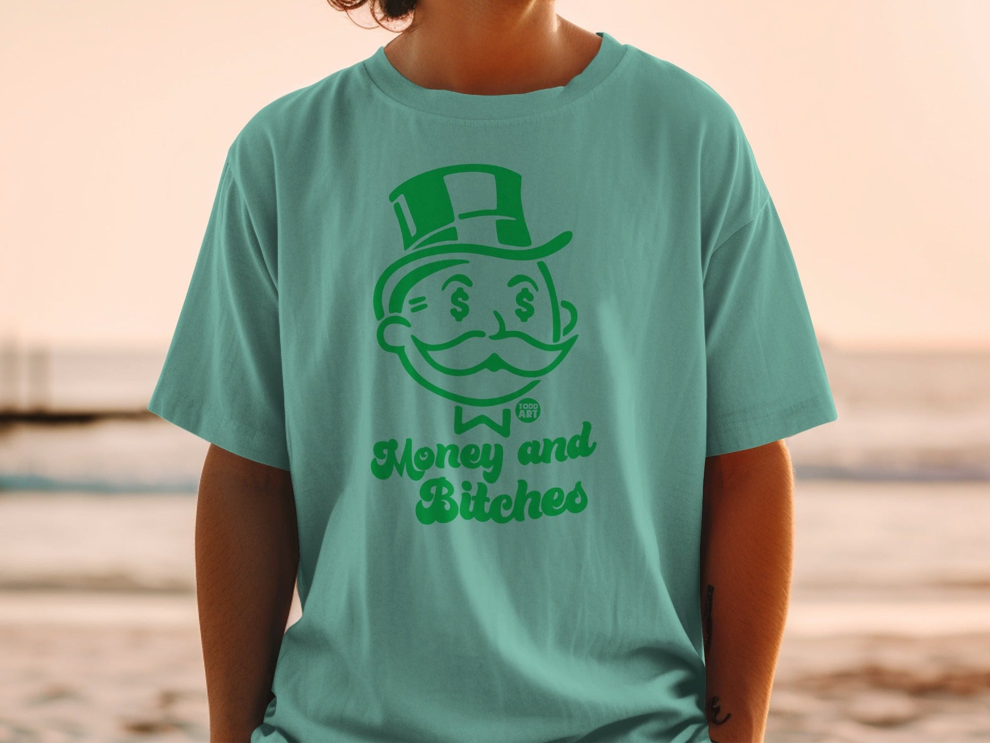 Teal t-shirt with Monopoly Man and "Money and Bitches" text.