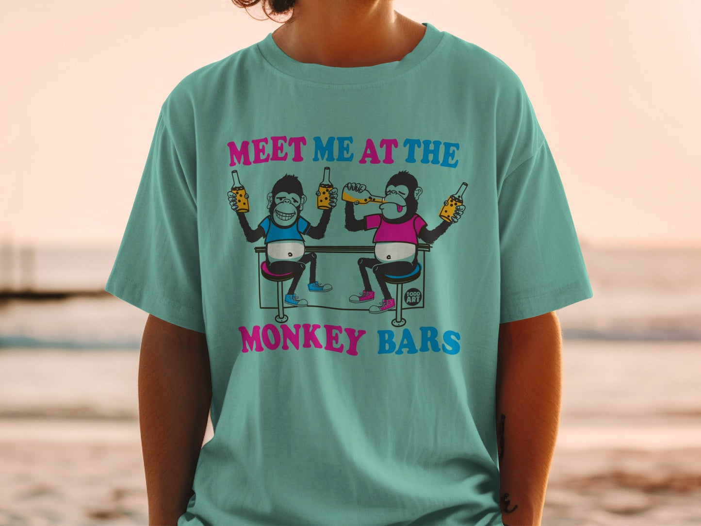 Two cartoon monkeys drinking beer at a bar, text "MEET ME AT THE MONKEY BARS".