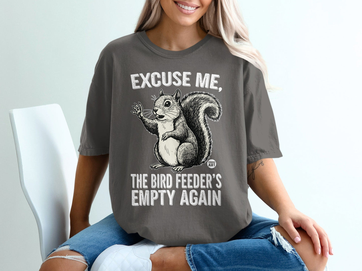 T-shirt with squirrel graphic and text "Excuse me, the bird feeder's empty again."
