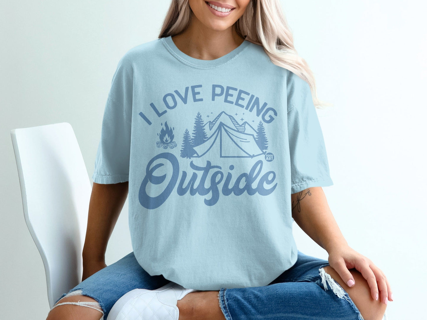 Light blue t-shirt with "I Love Peeing Outside" and camping graphics.