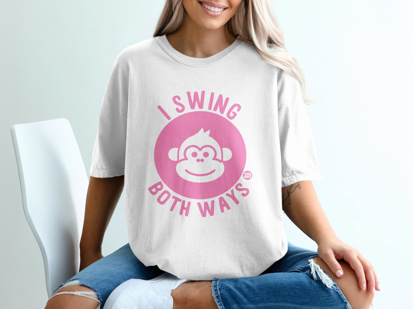 White t-shirt with pink monkey face and text "I SWING BOTH WAYS".