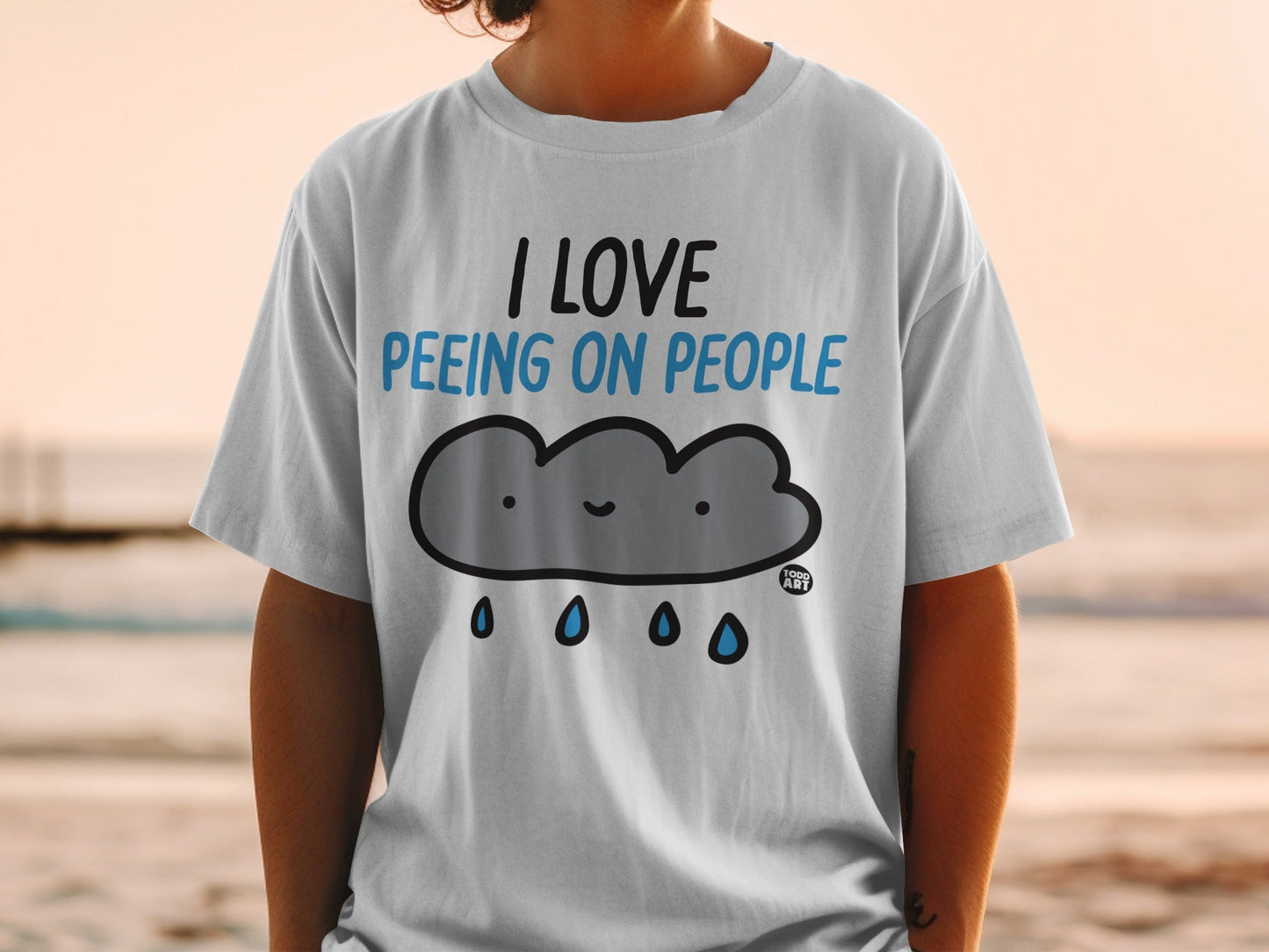 White t-shirt with "I love peeing on people" text and cartoon cloud.