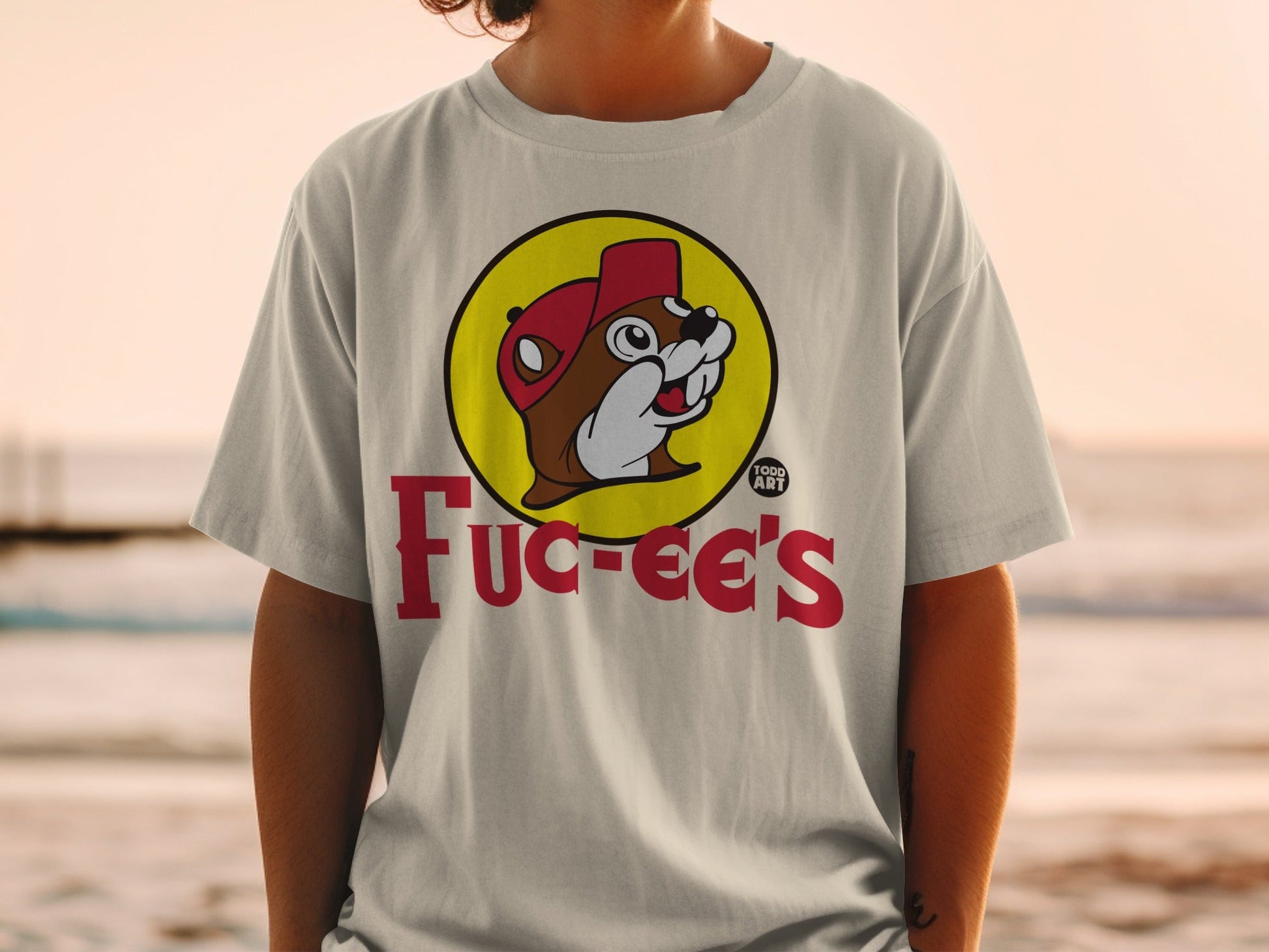 Bucee's beaver logo on a cream t-shirt worn by a person.