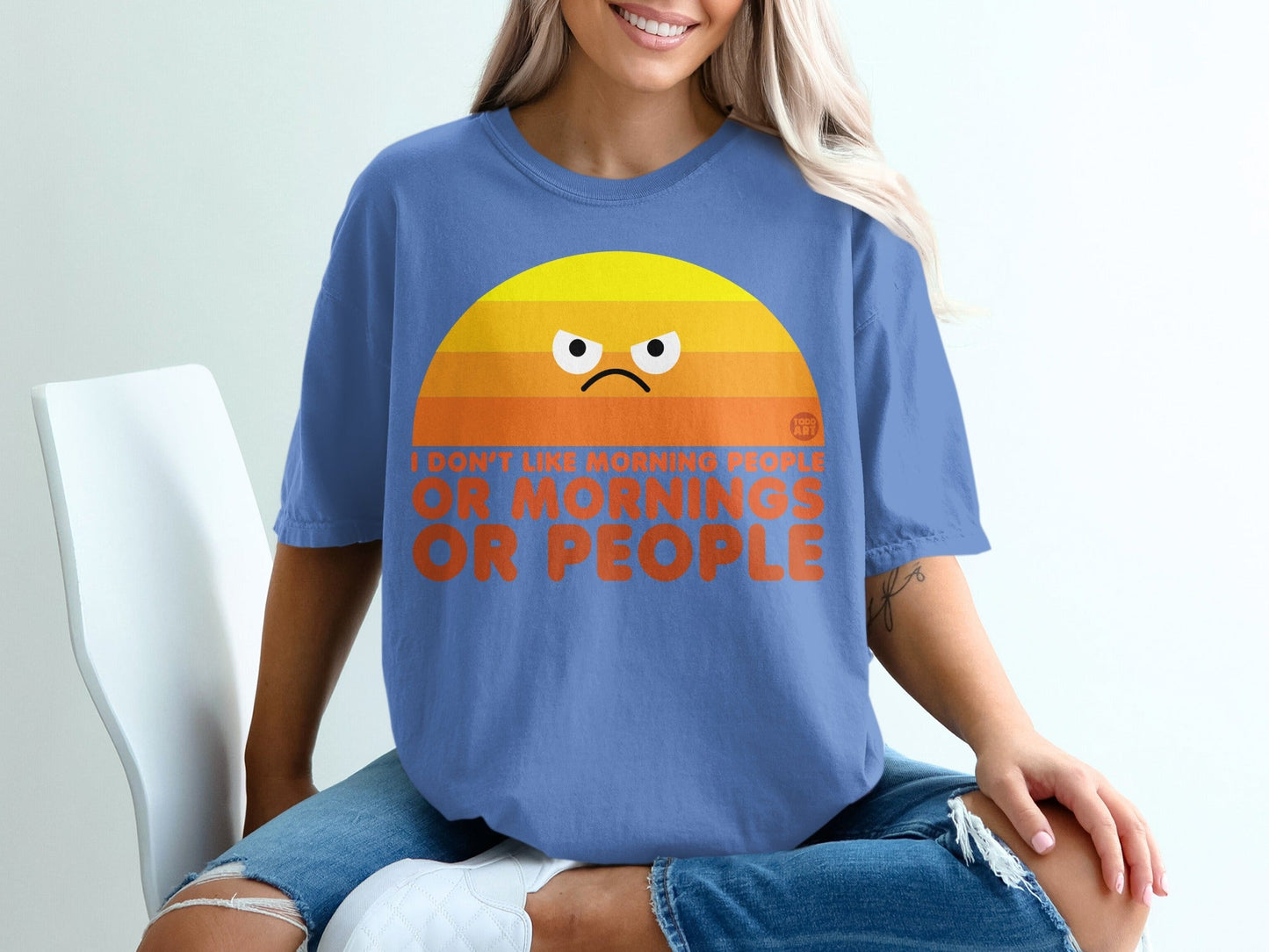 Blue t-shirt with orange sunrise graphic and text "I don't like morning people or mornings."