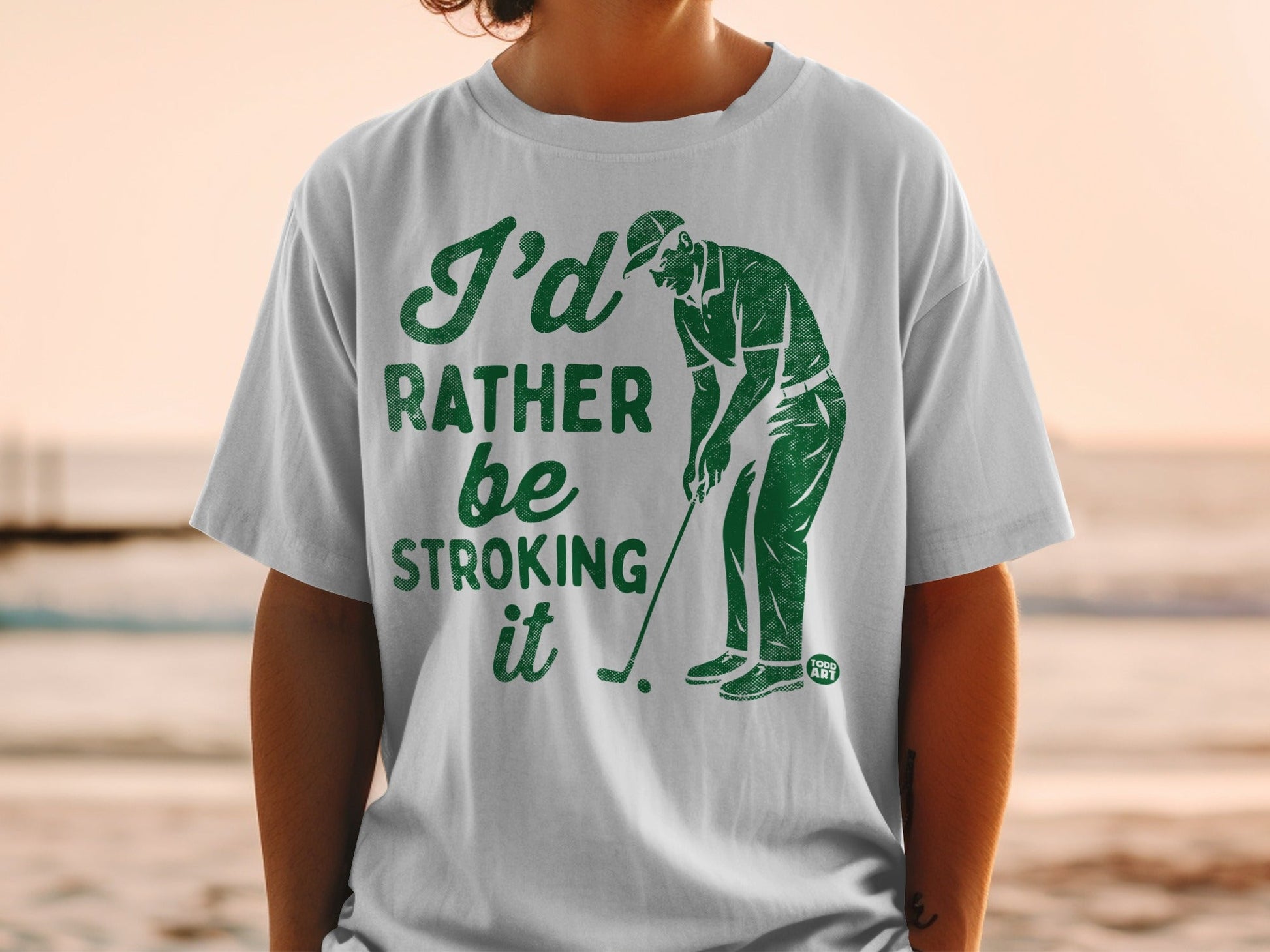 Green t-shirt with "I'd Rather Be Stroking It" golf graphic.