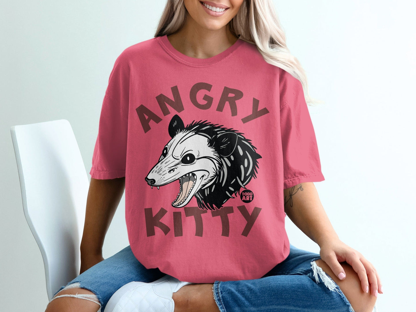 Pink t-shirt with an angry possum design and "ANGRY KITTY" text.