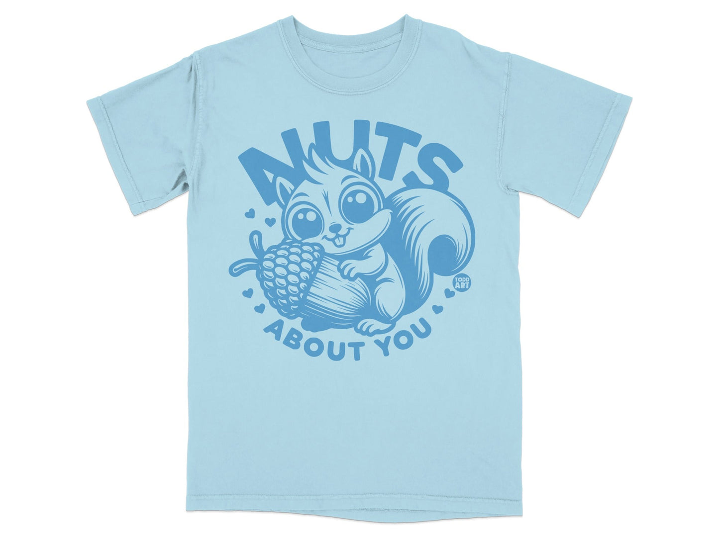 Light blue t-shirt with a blue graphic of a squirrel holding an acorn and text reading "NUTS ABOUT YOU".