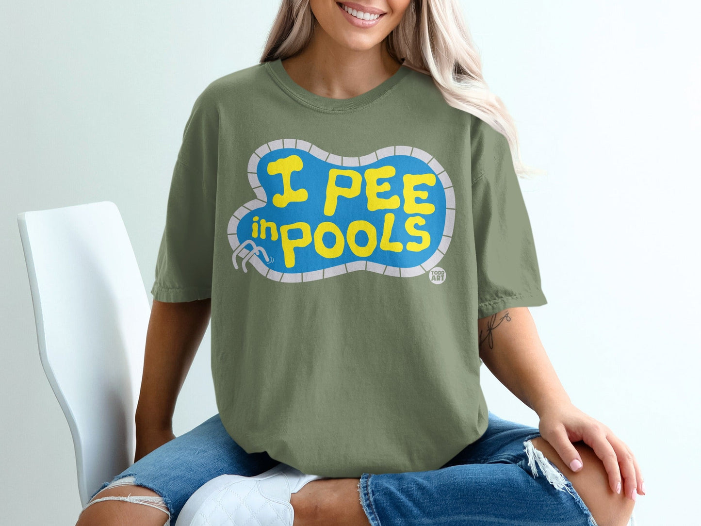 Green t-shirt with blue text that reads "I PEE in POOLS".