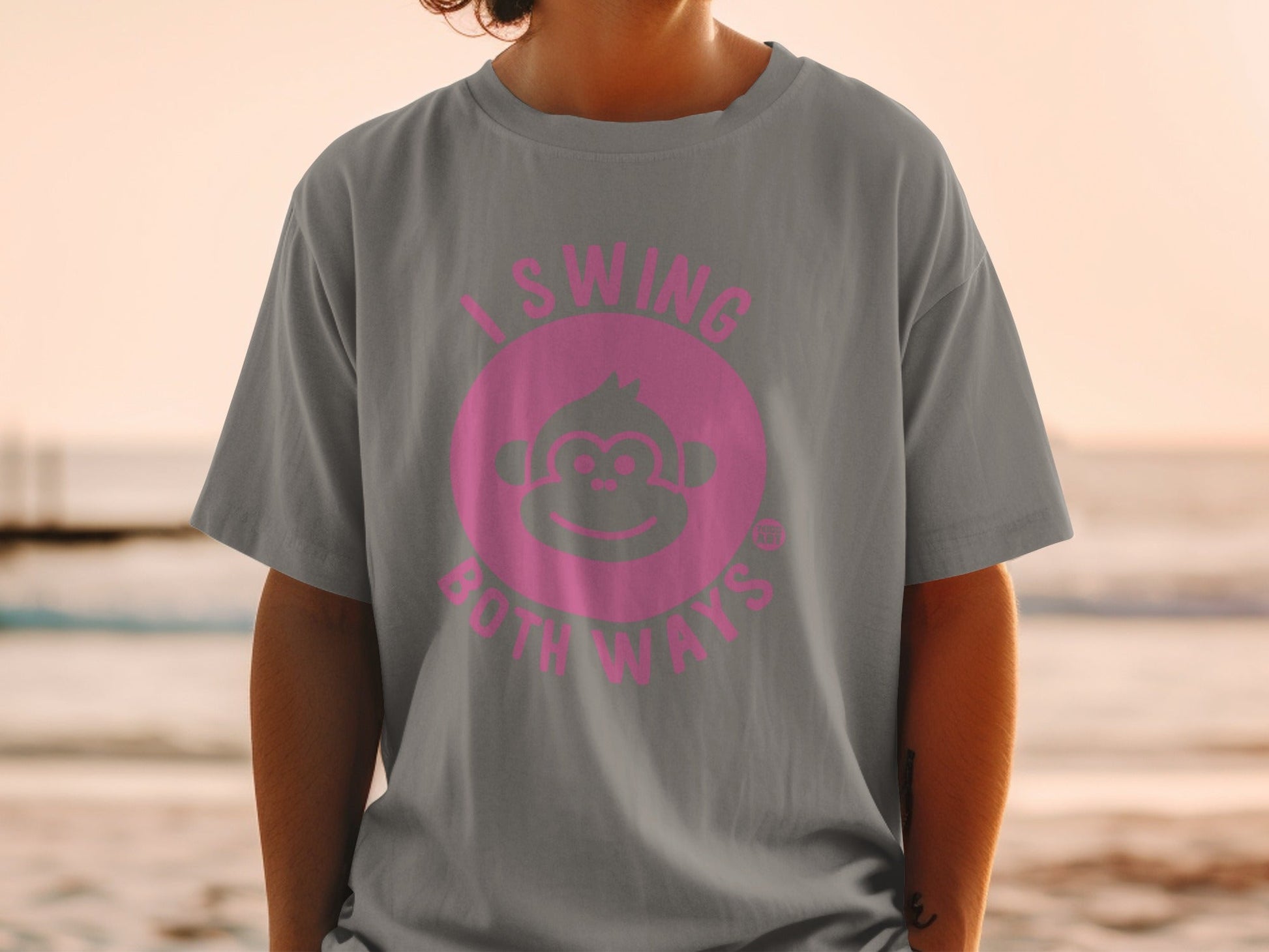 Grey t-shirt with pink monkey logo and text "I swing both ways."