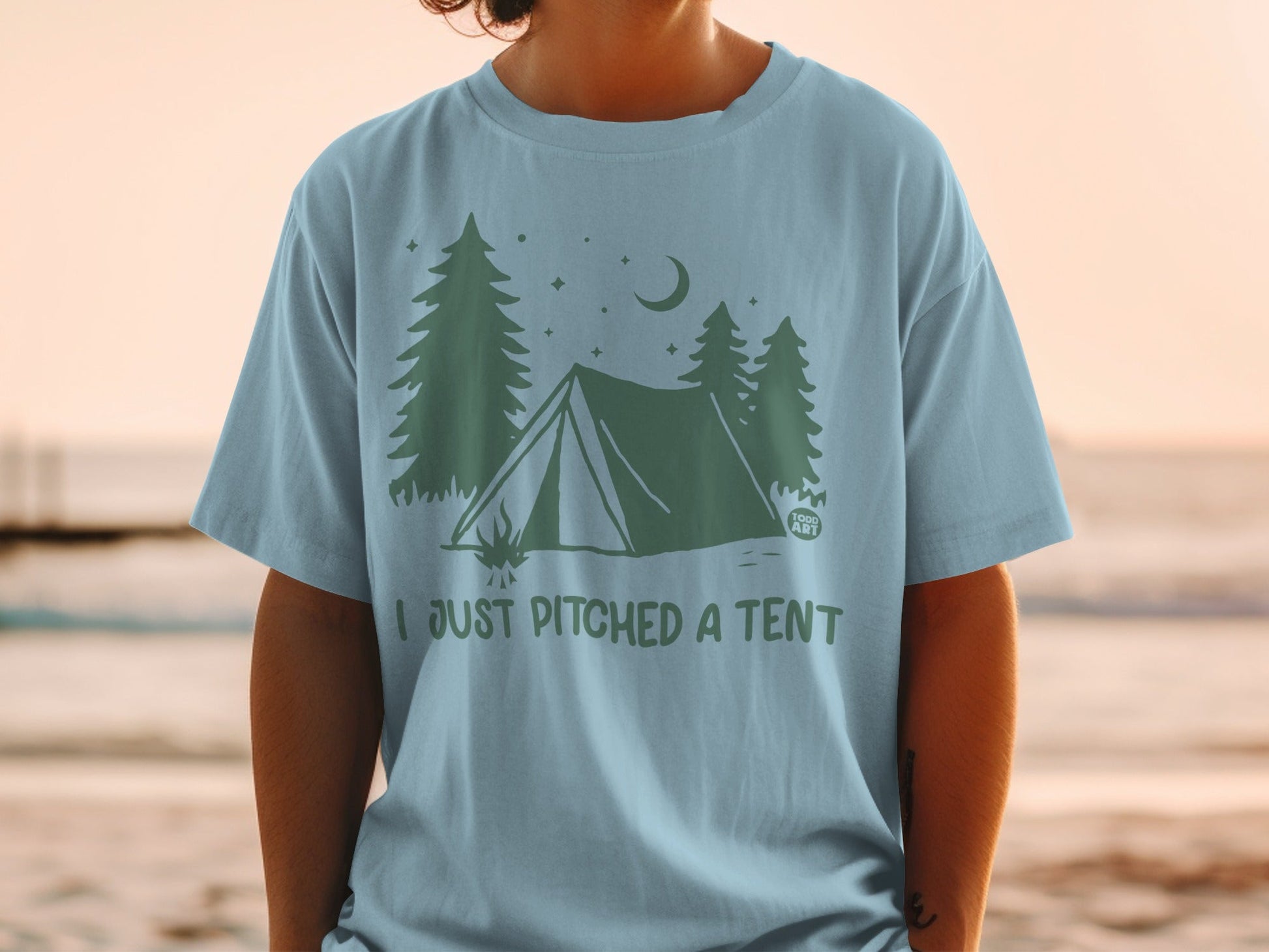 Light blue t-shirt with tent, trees, moon, and "I JUST PITCHED A TENT" text.