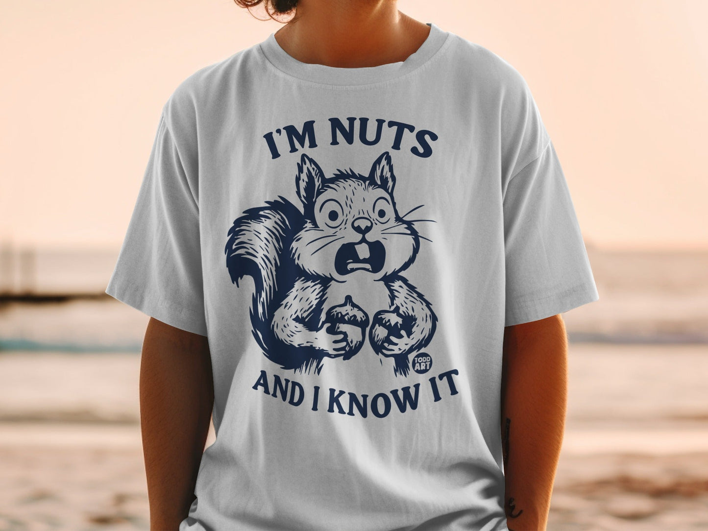T-shirt with a surprised squirrel holding nuts and text "I'M NUTS AND I KNOW IT".