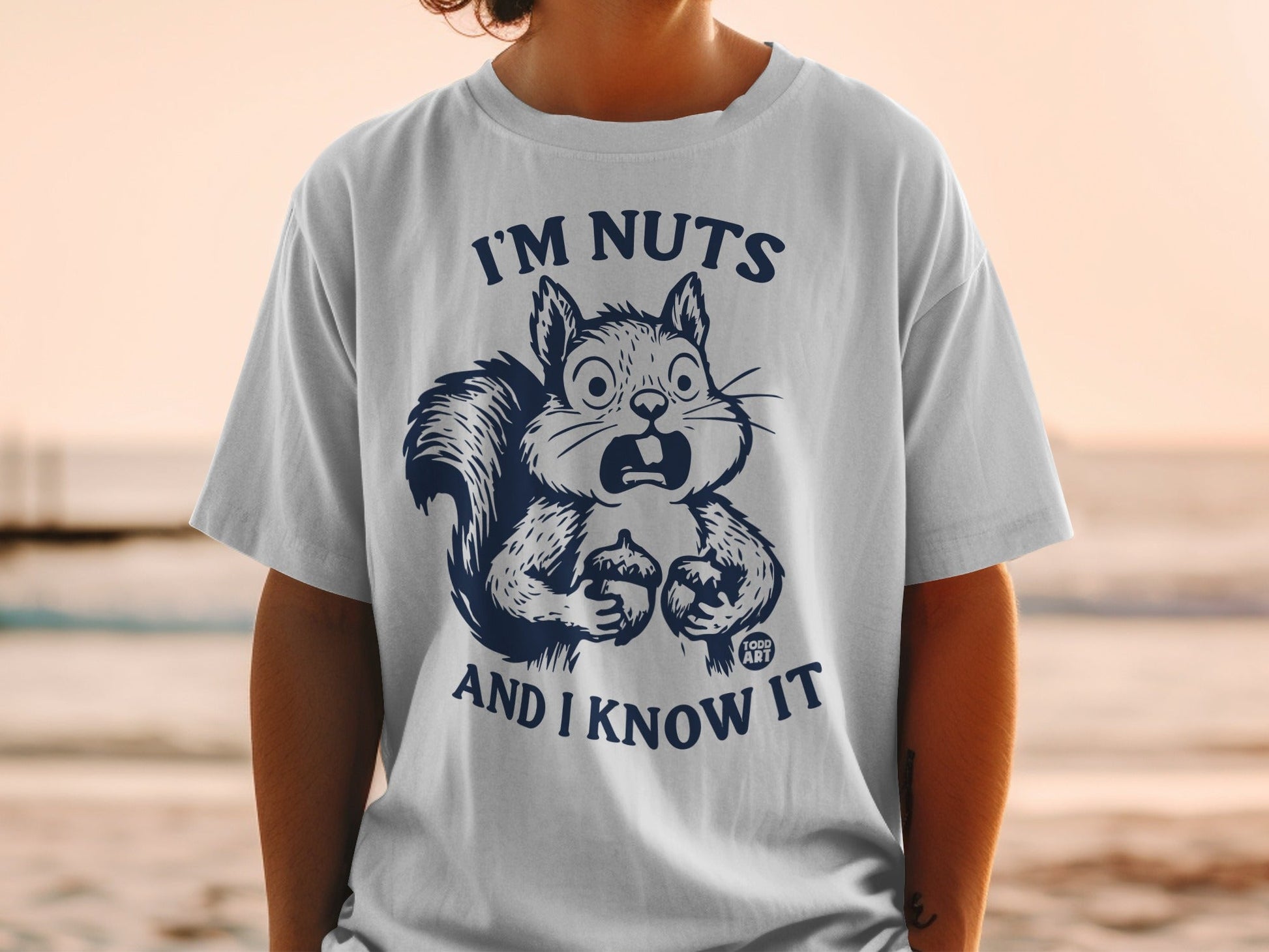 T-shirt with a surprised squirrel holding nuts and text "I'M NUTS AND I KNOW IT".