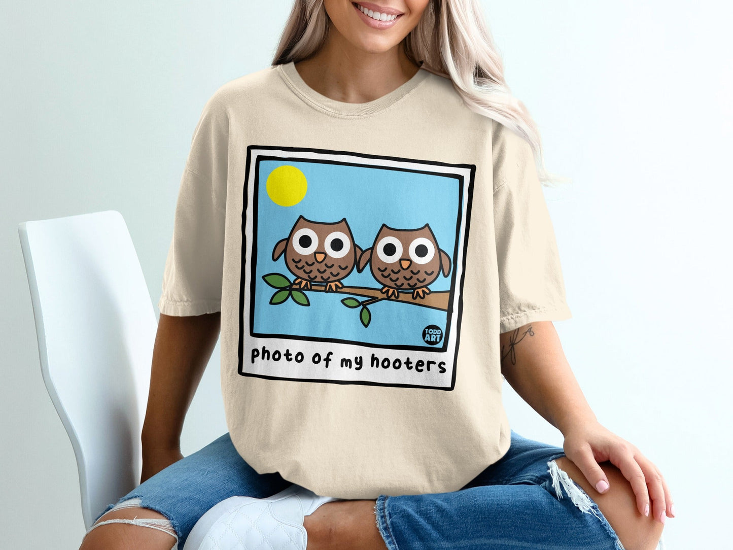 Two cartoon owls perched on a branch, text "photo of my hooters".