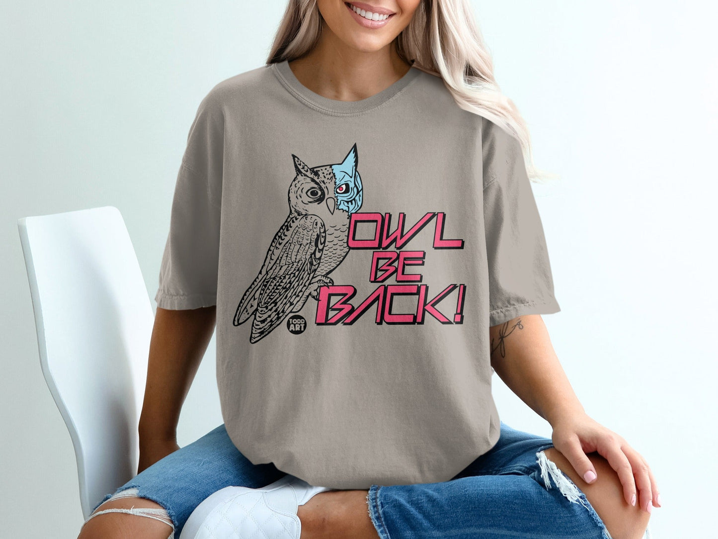 T-shirt with an owl partially masked and text "OWL BE BACK!".