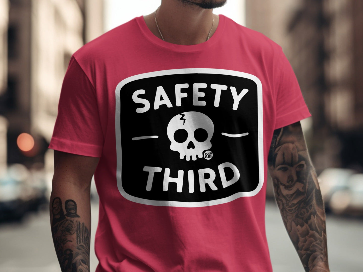 Pink t-shirt with "SAFETY THIRD" text and skull graphic.