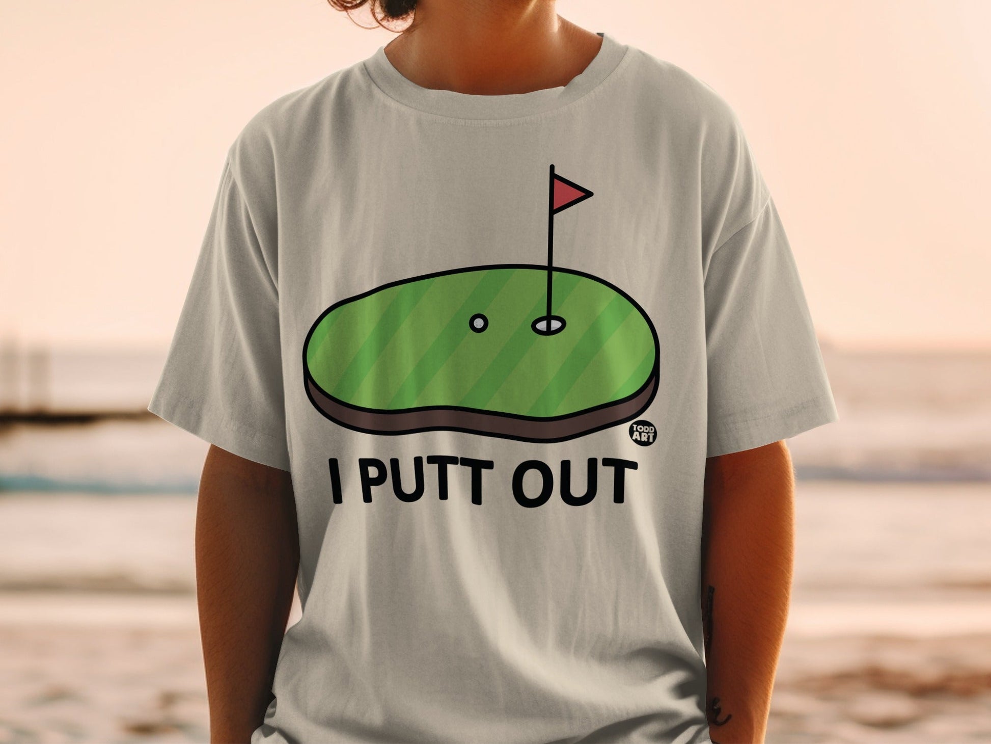 Gray t-shirt with "I PUTT OUT" text and golf green graphic.