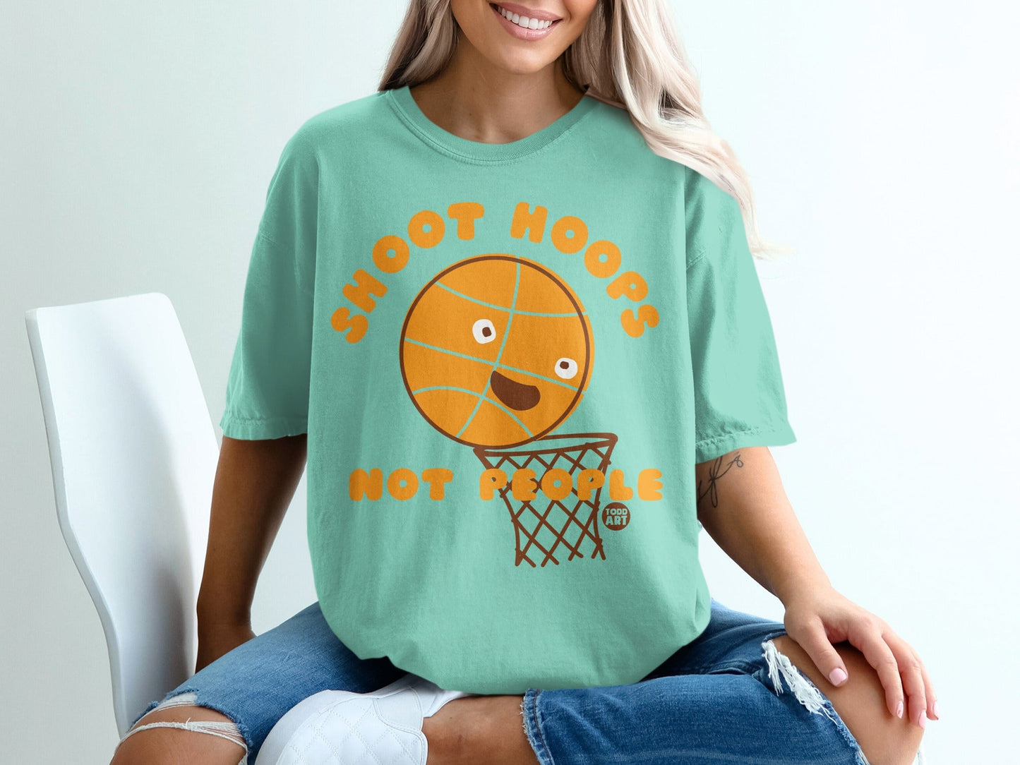 Teal t-shirt with a cartoon basketball and hoop graphic.