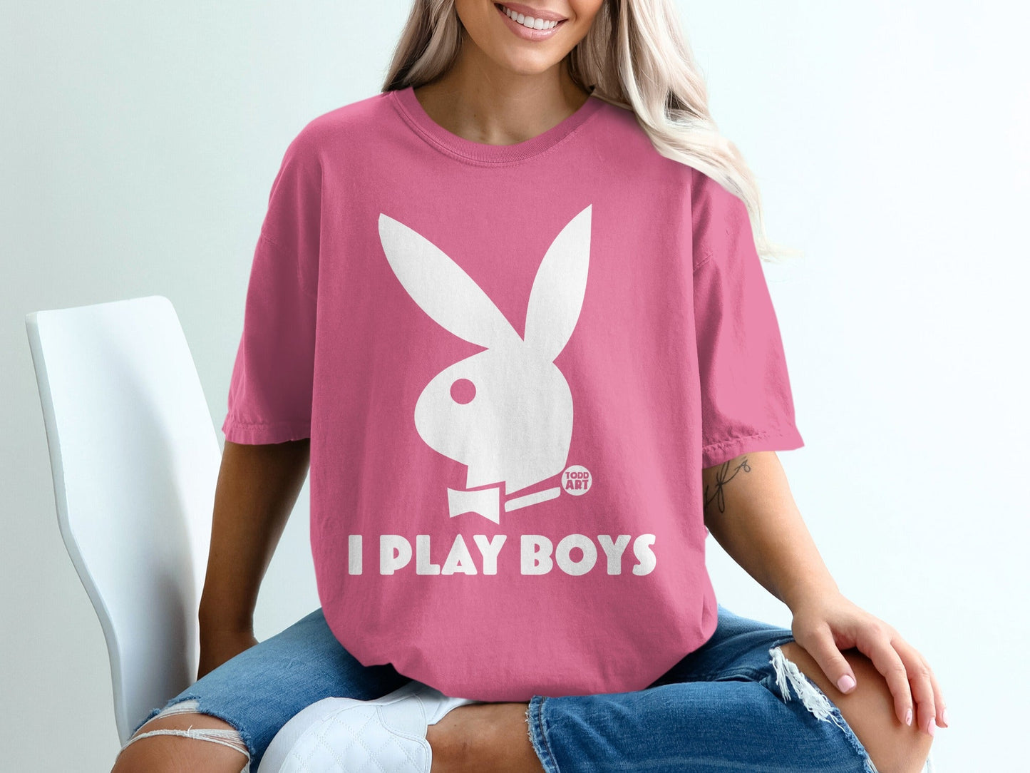 Pink t-shirt with white Playboy bunny logo and text "I PLAY BOYS".