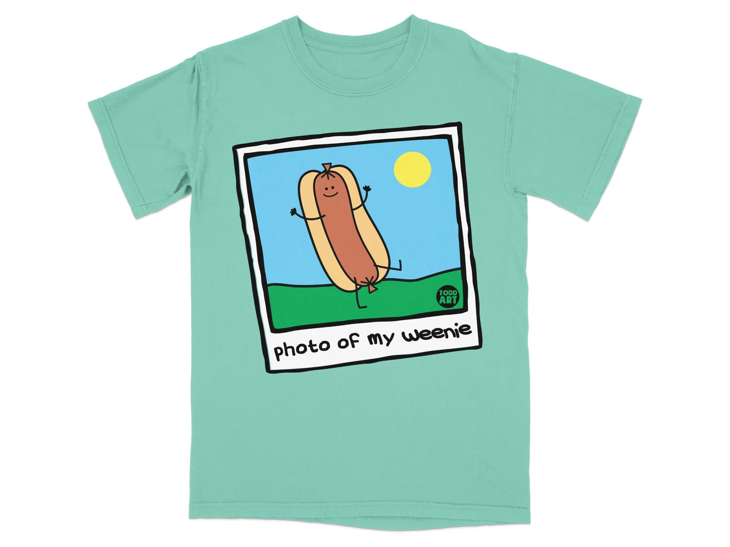 Cartoon hot dog with a smile and outstretched arms on grass with a sun.